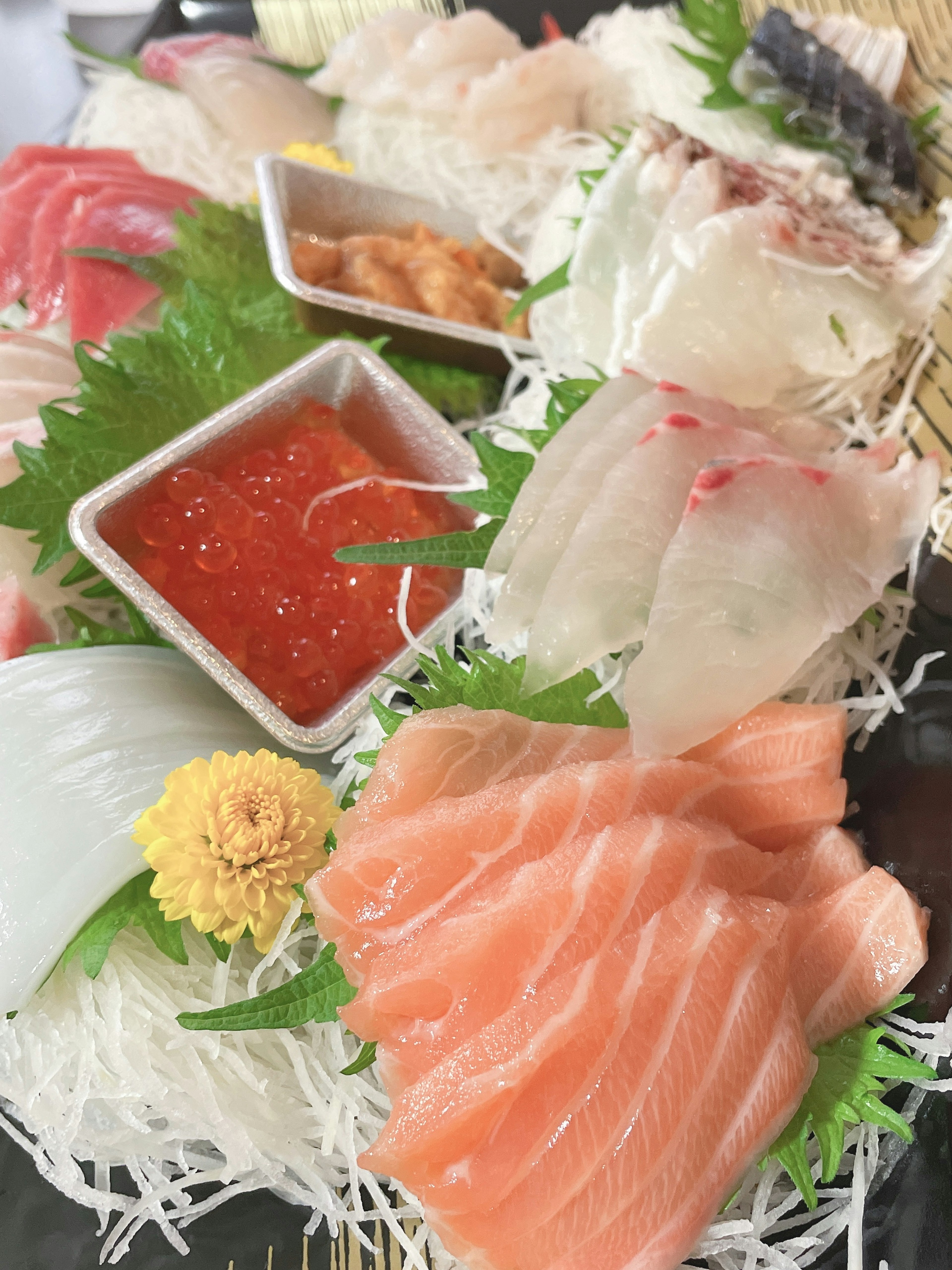 A beautiful sushi platter featuring a variety of sashimi and garnishes