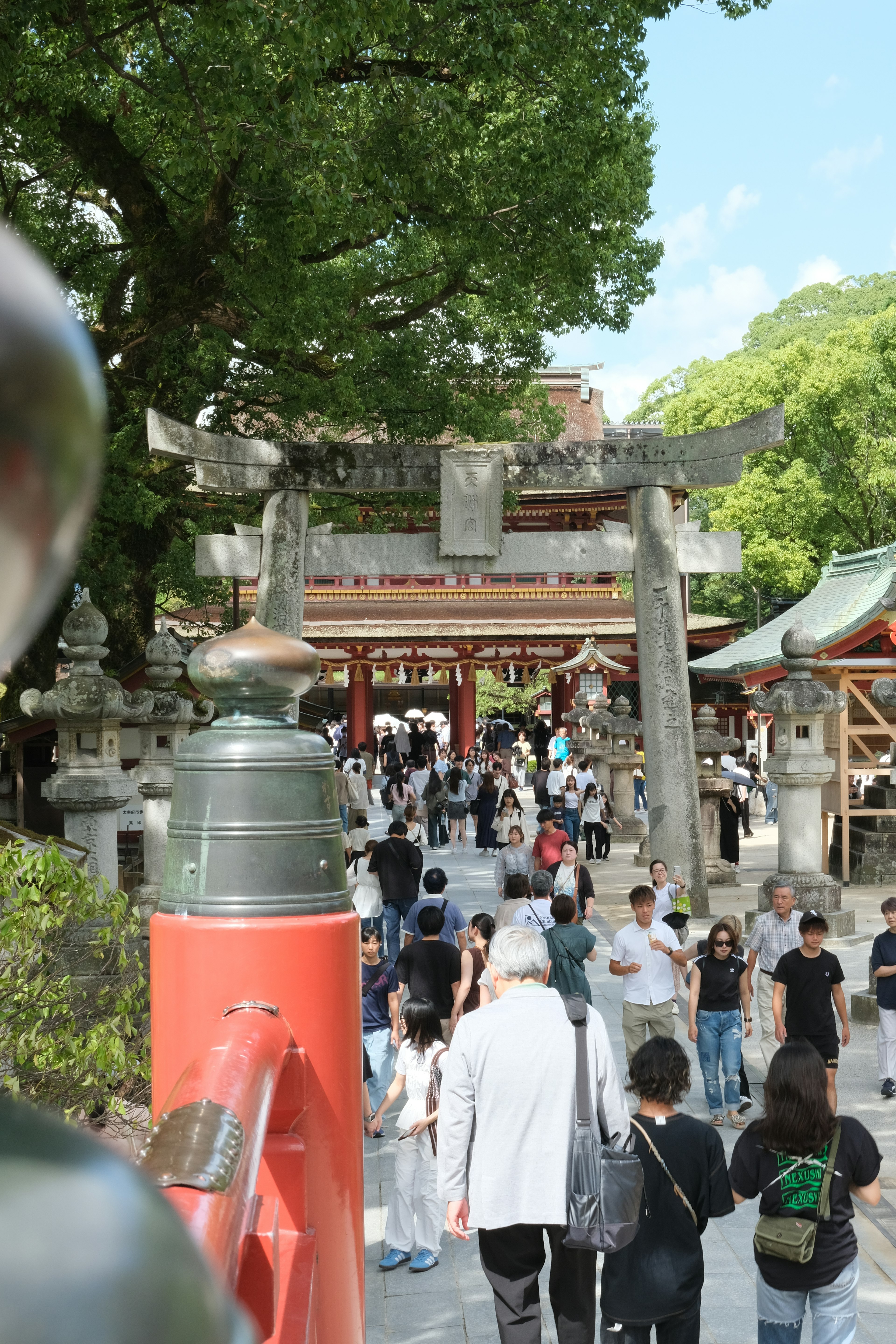 人群聚集在神社入口处，蓝天