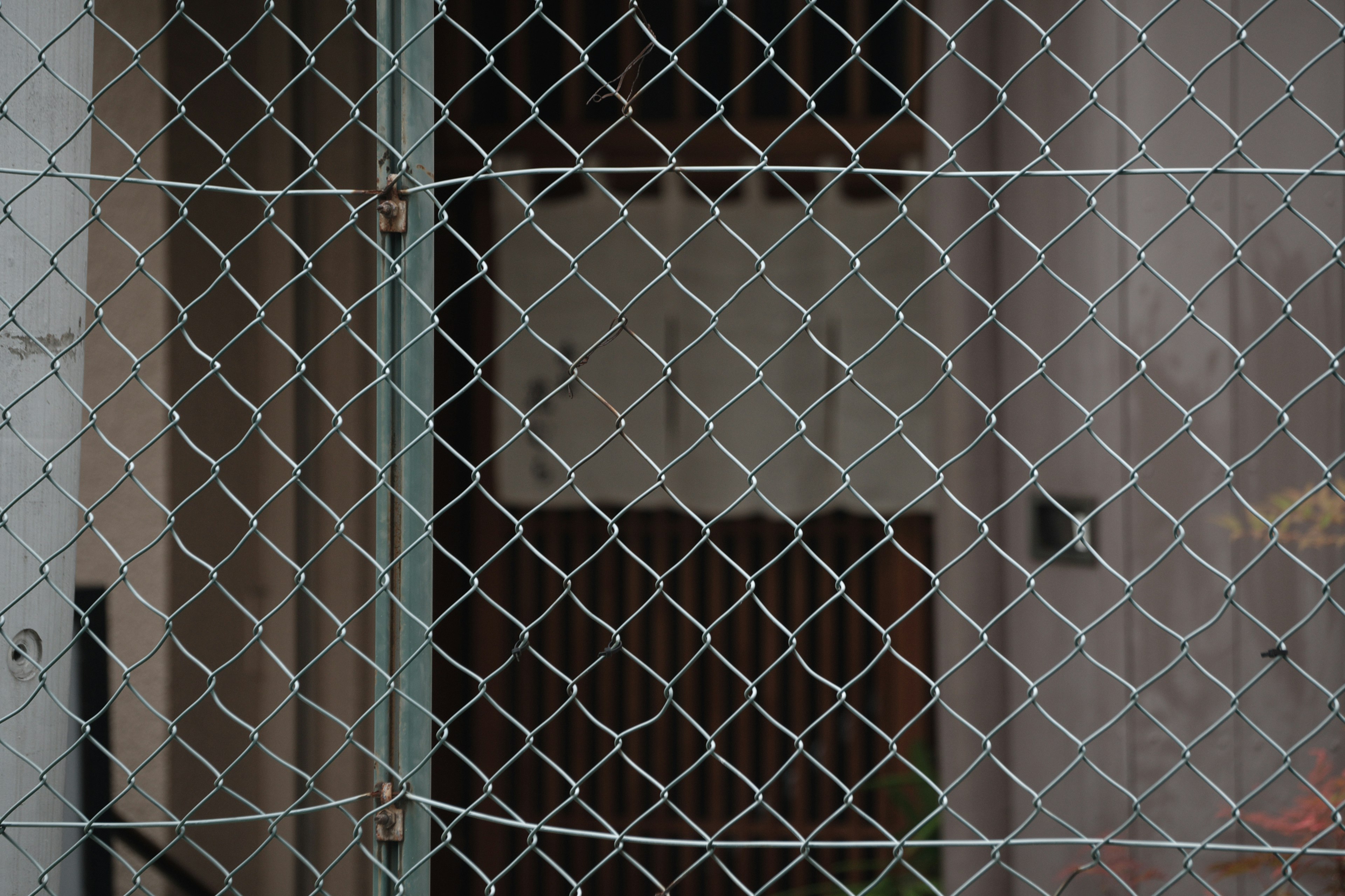 A section of a building visible behind a metal fence