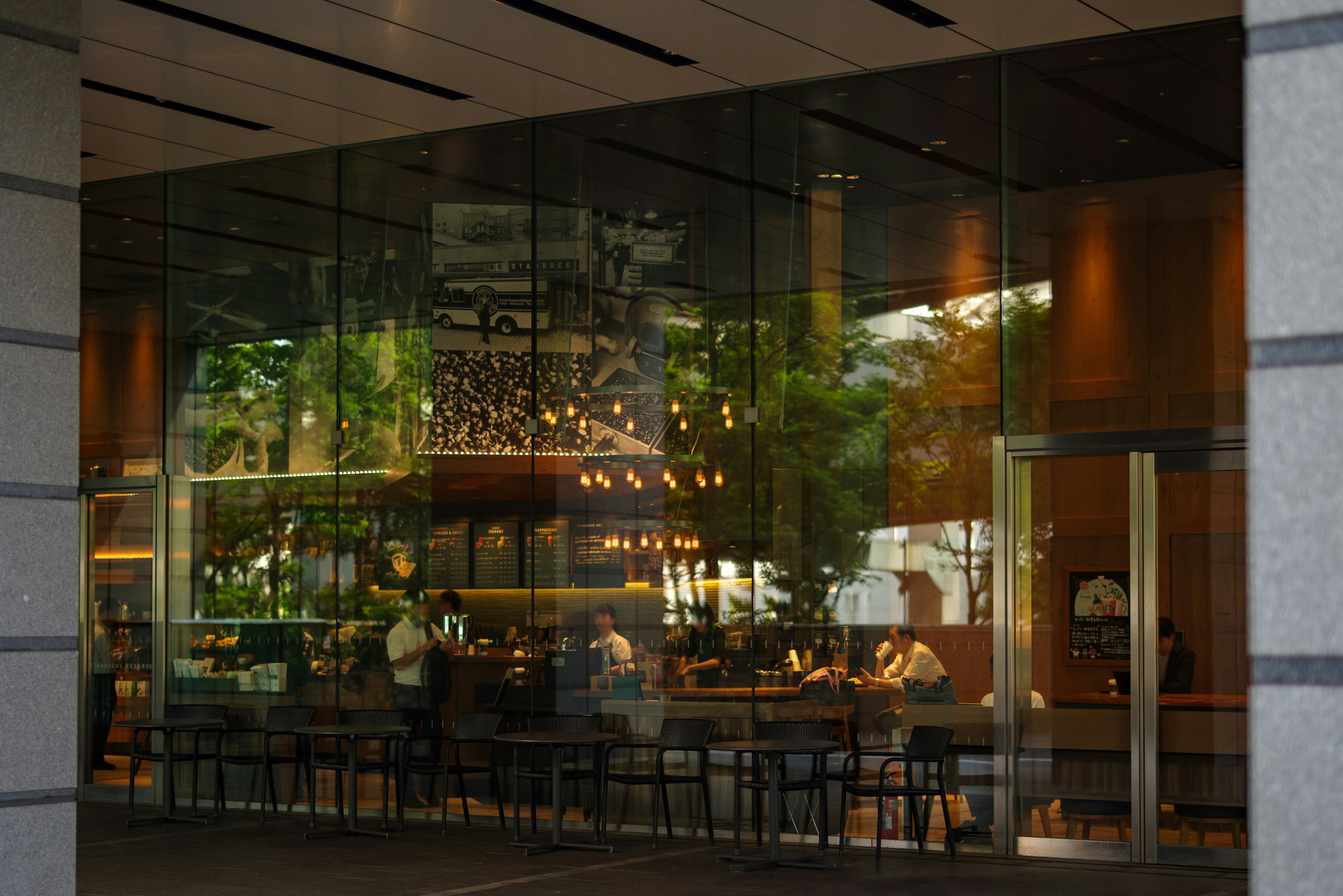 Interior of a glass-fronted café with people seated