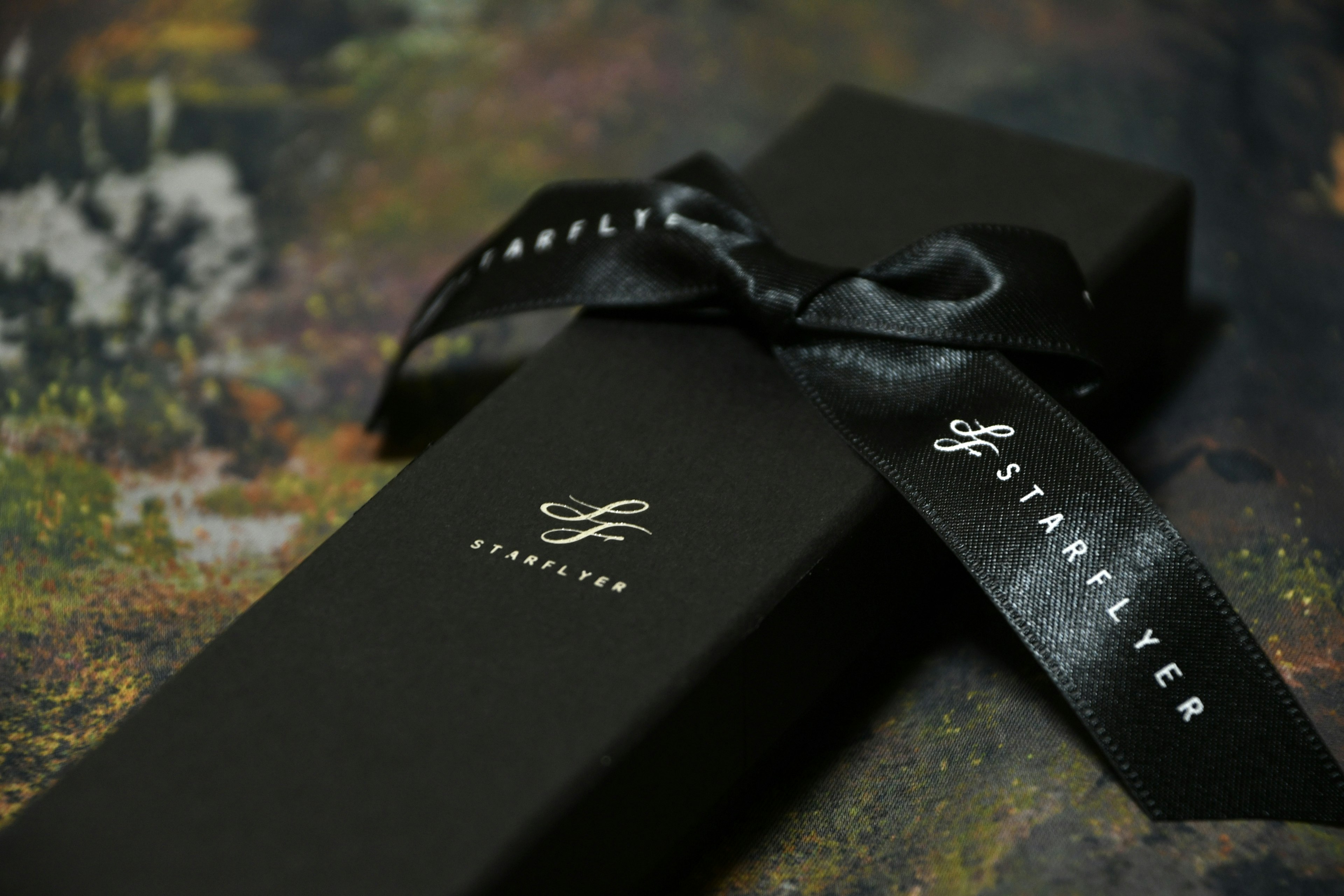 Elegant black gift box with a ribbon showcasing luxury packaging