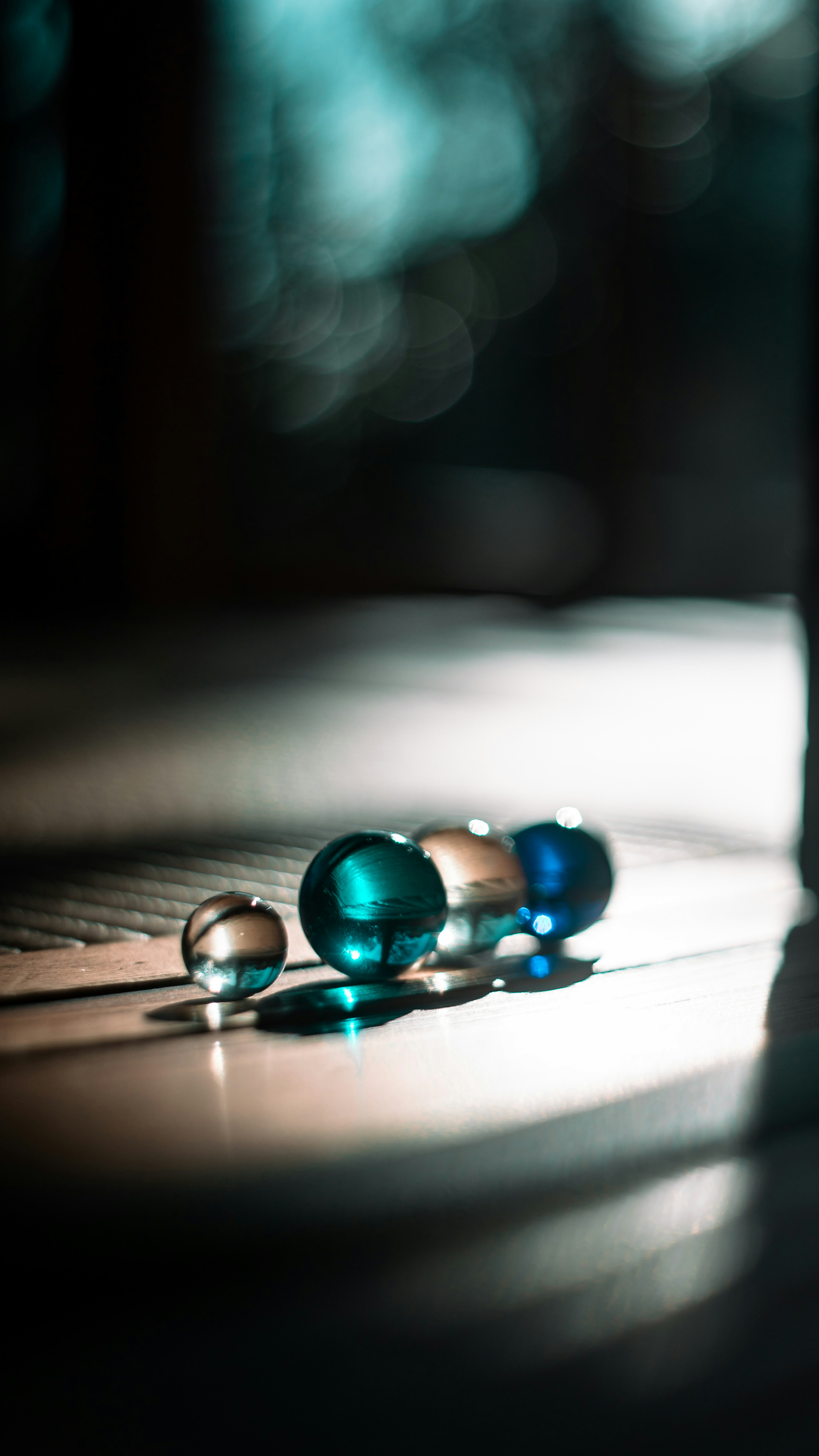 Photo of blue and clear marbles reflecting light