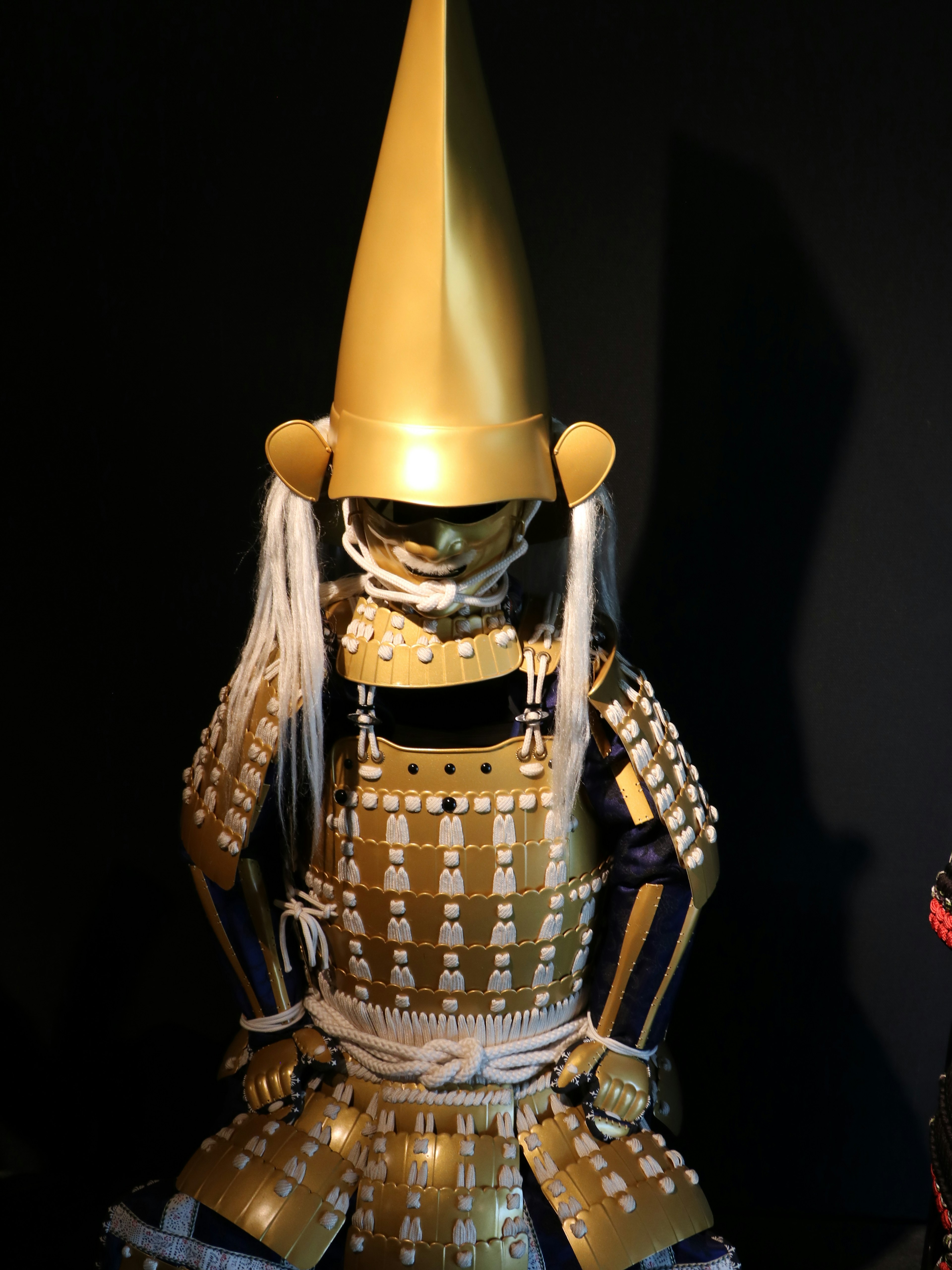 Japanese armor displayed with a golden helmet and intricate details