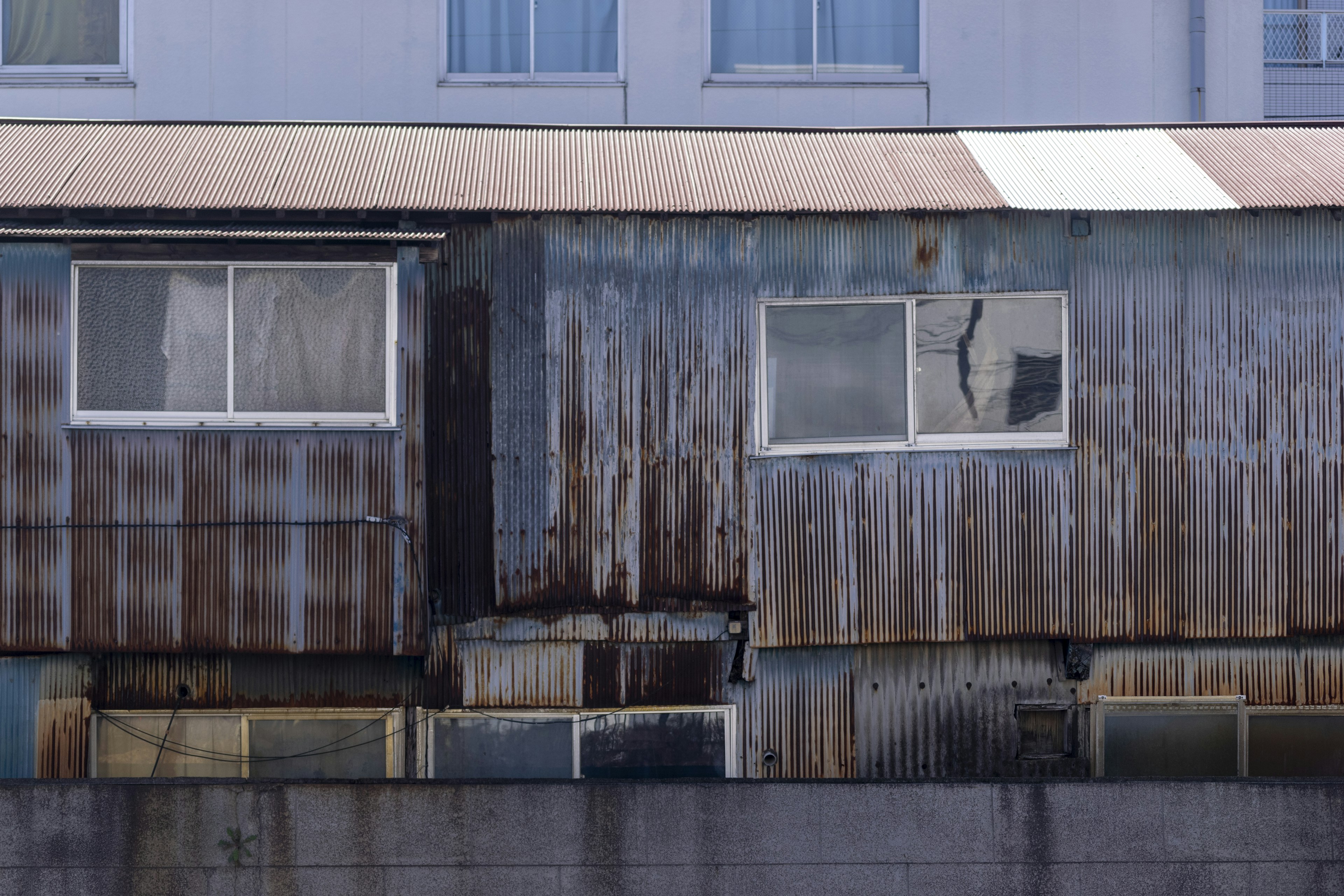 Exterior of an old metal building with windows