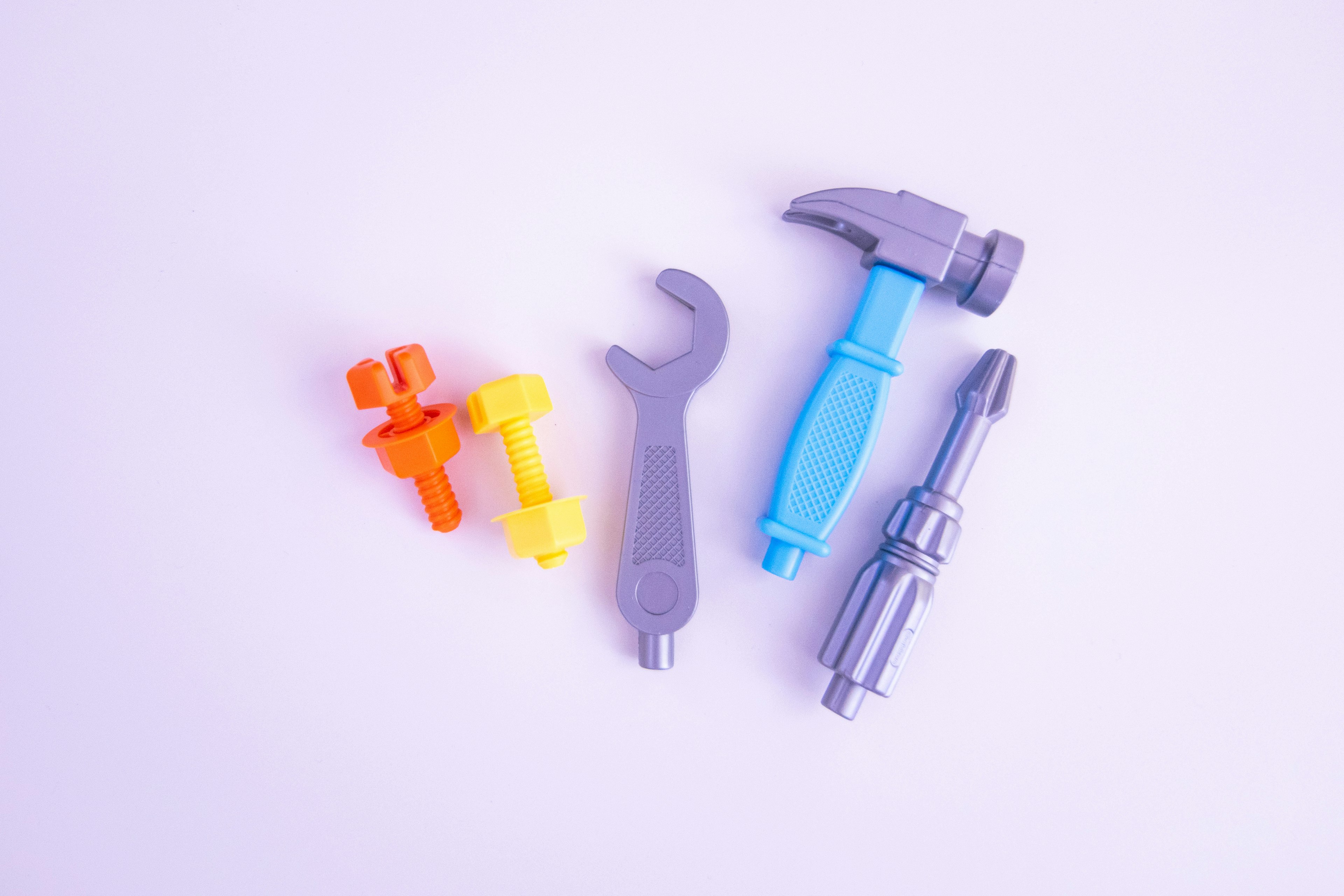 Colorful plastic tools arranged on a white background