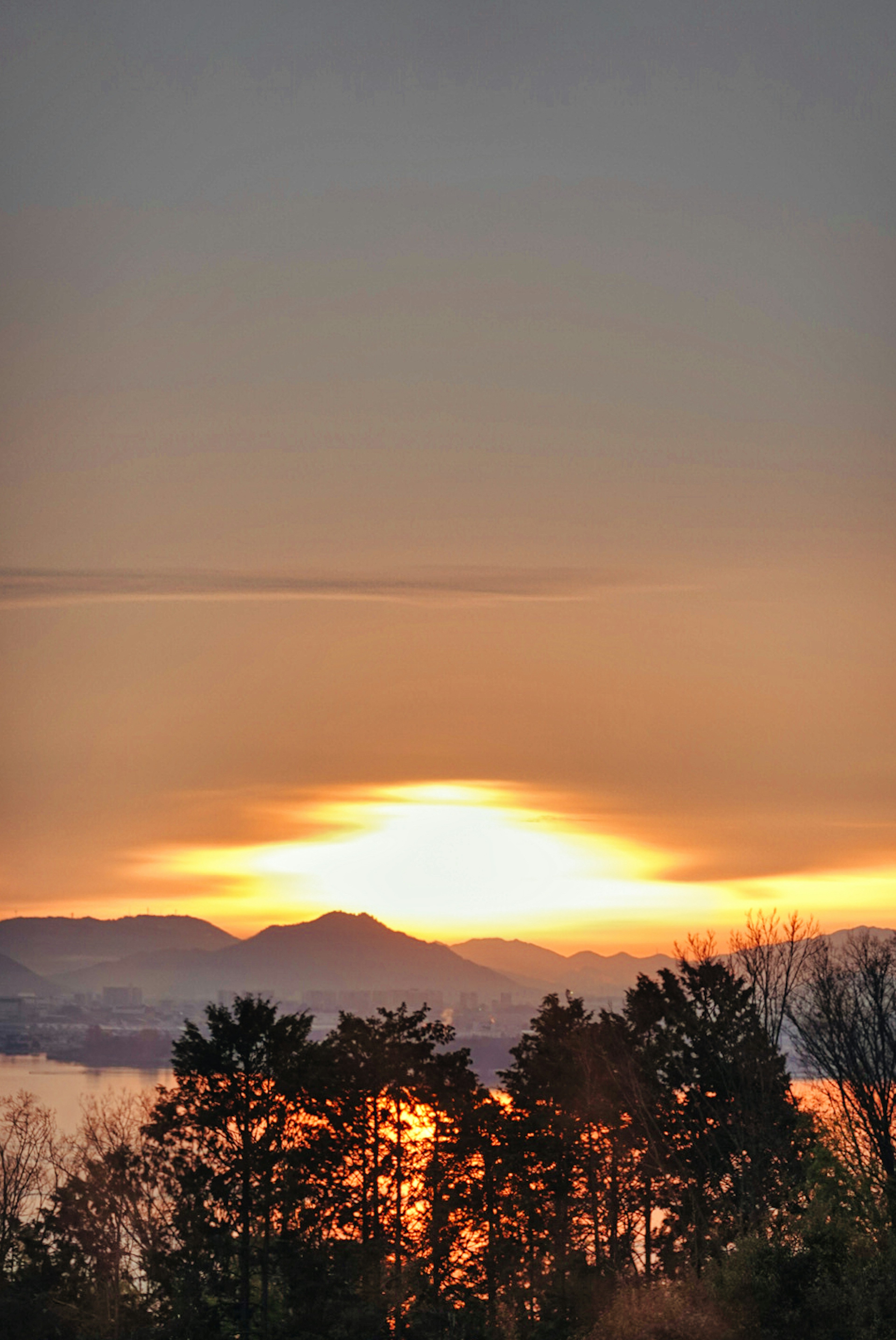 夕日が山々の間に沈む美しい風景