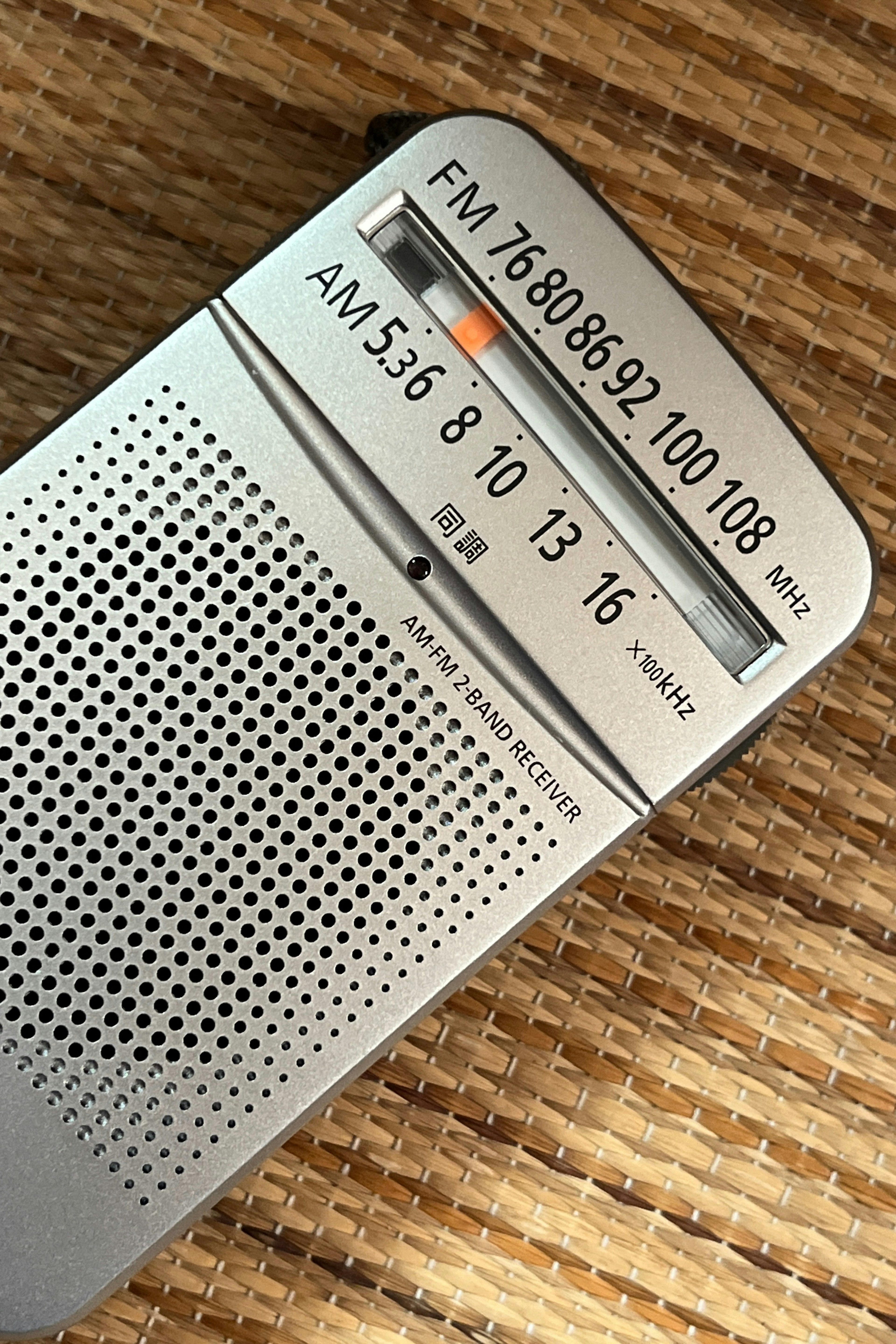 Silver radio displaying FM and AM frequencies