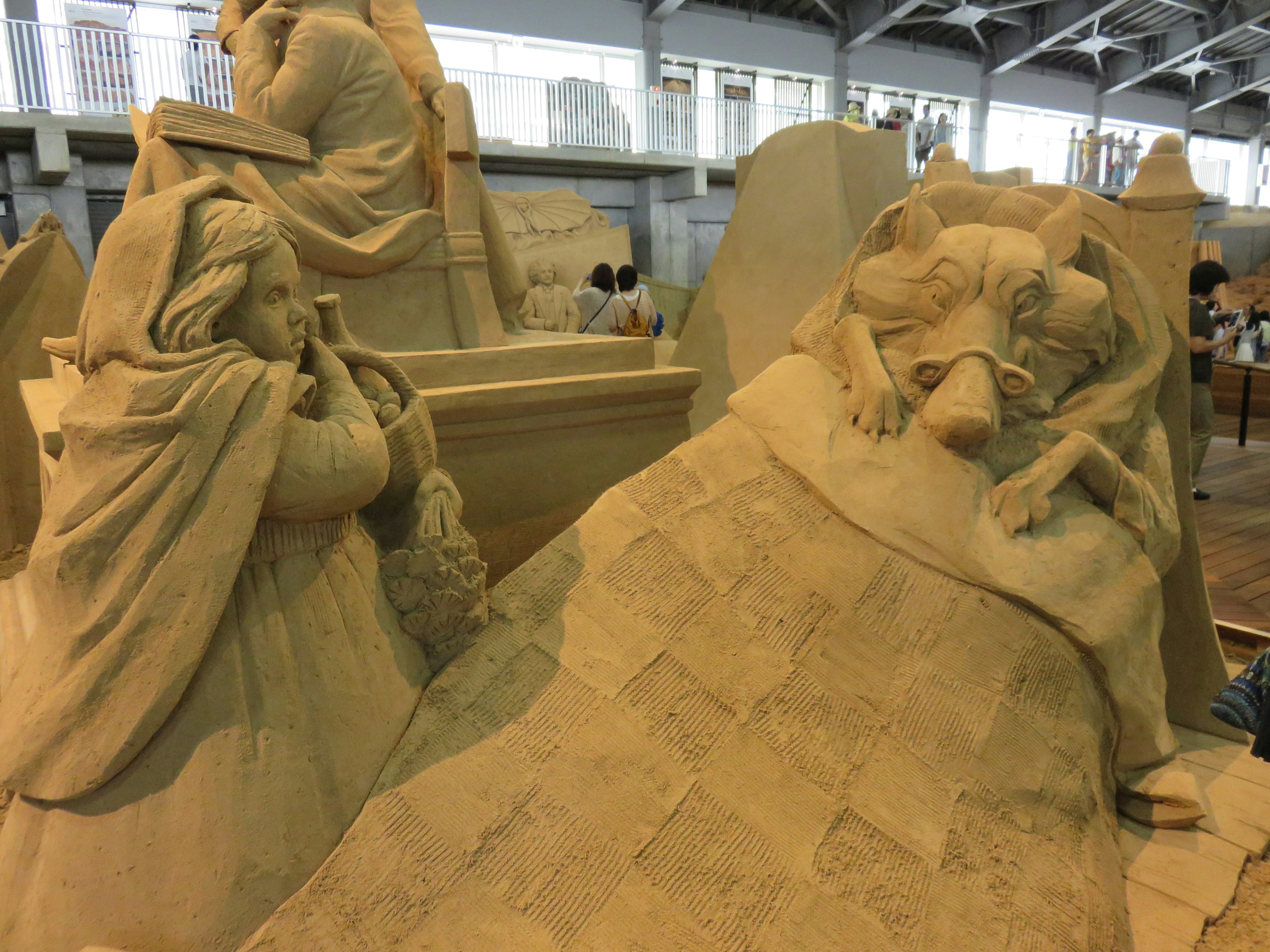 Detailed display of sand sculptures at a sand sculpture festival