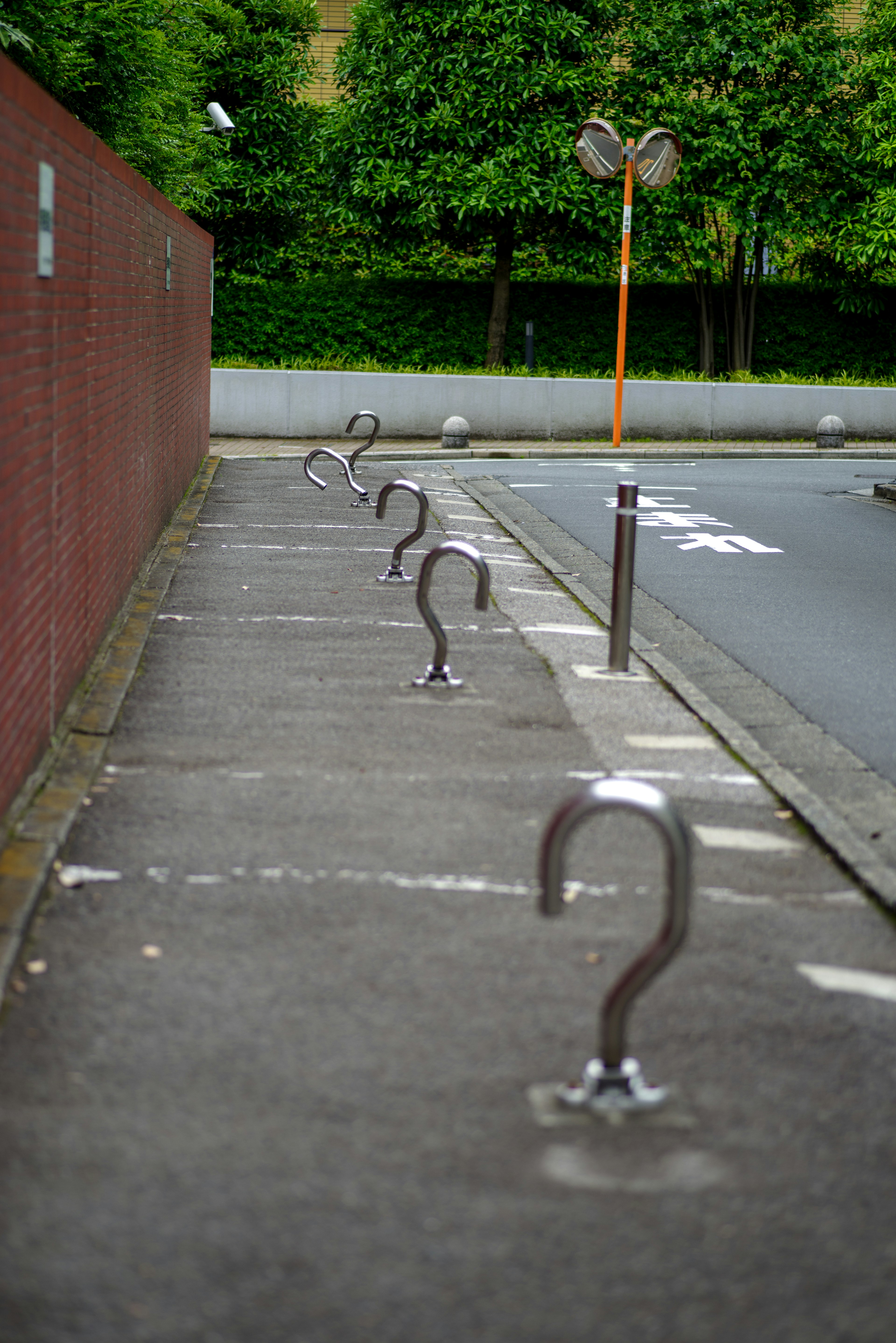 Row of metal hooks along a sidewalk