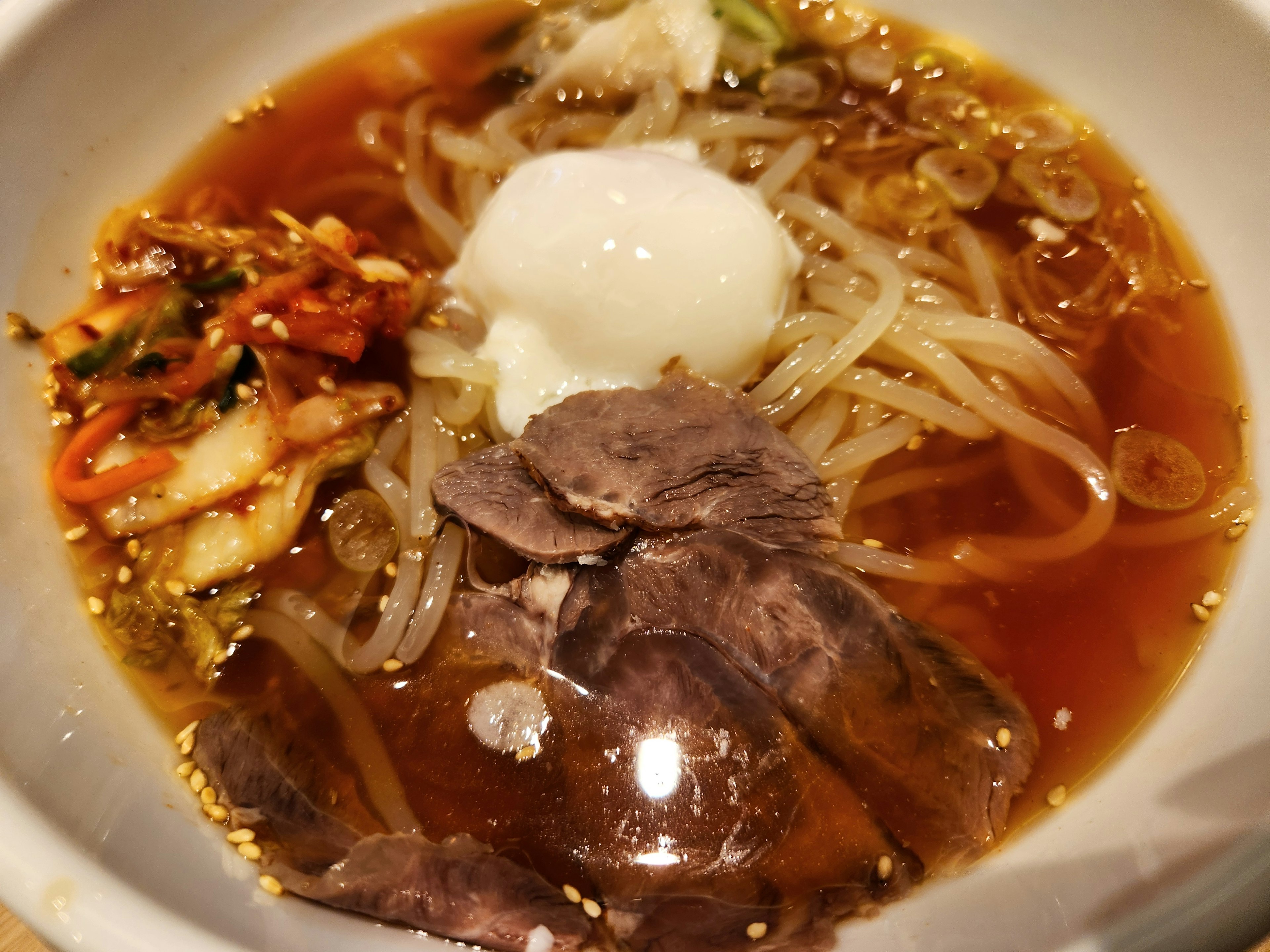 Delicious cold noodle dish with toppings of meat and egg