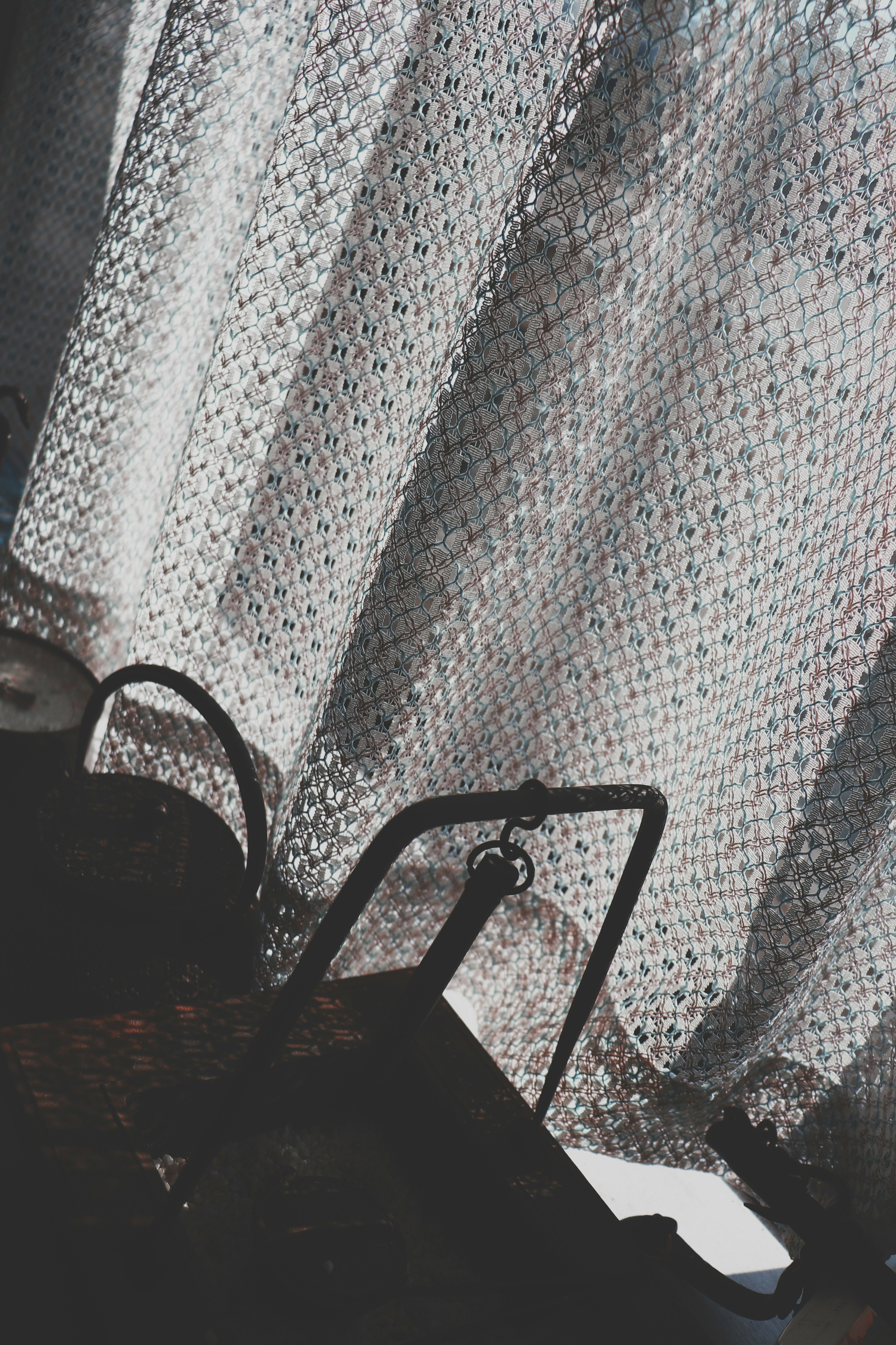 Close-up of a curtain and handbag in a dimly lit room