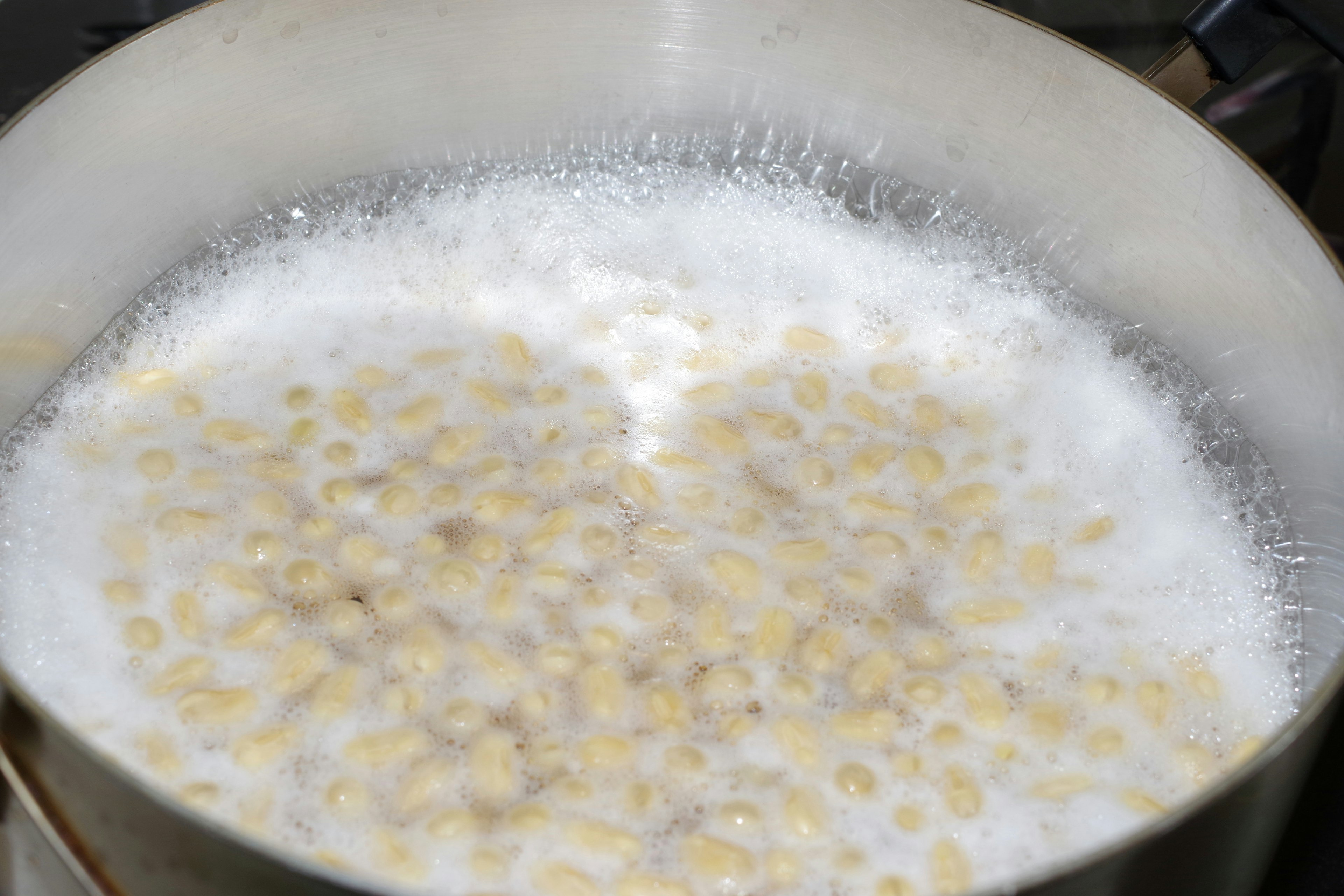 Boiling grains in a pot with bubbles