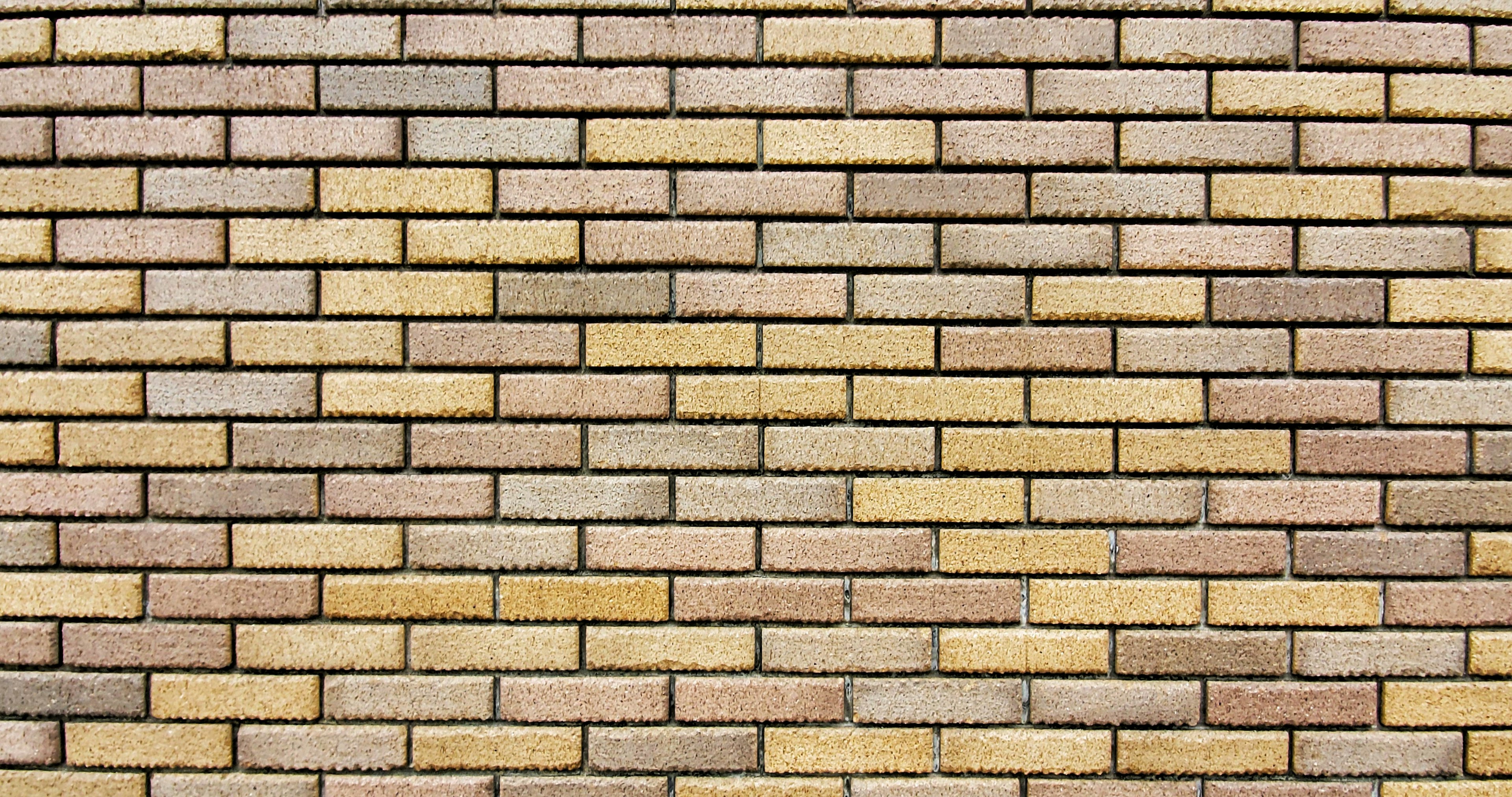 Texture d'un mur en briques jaunâtres