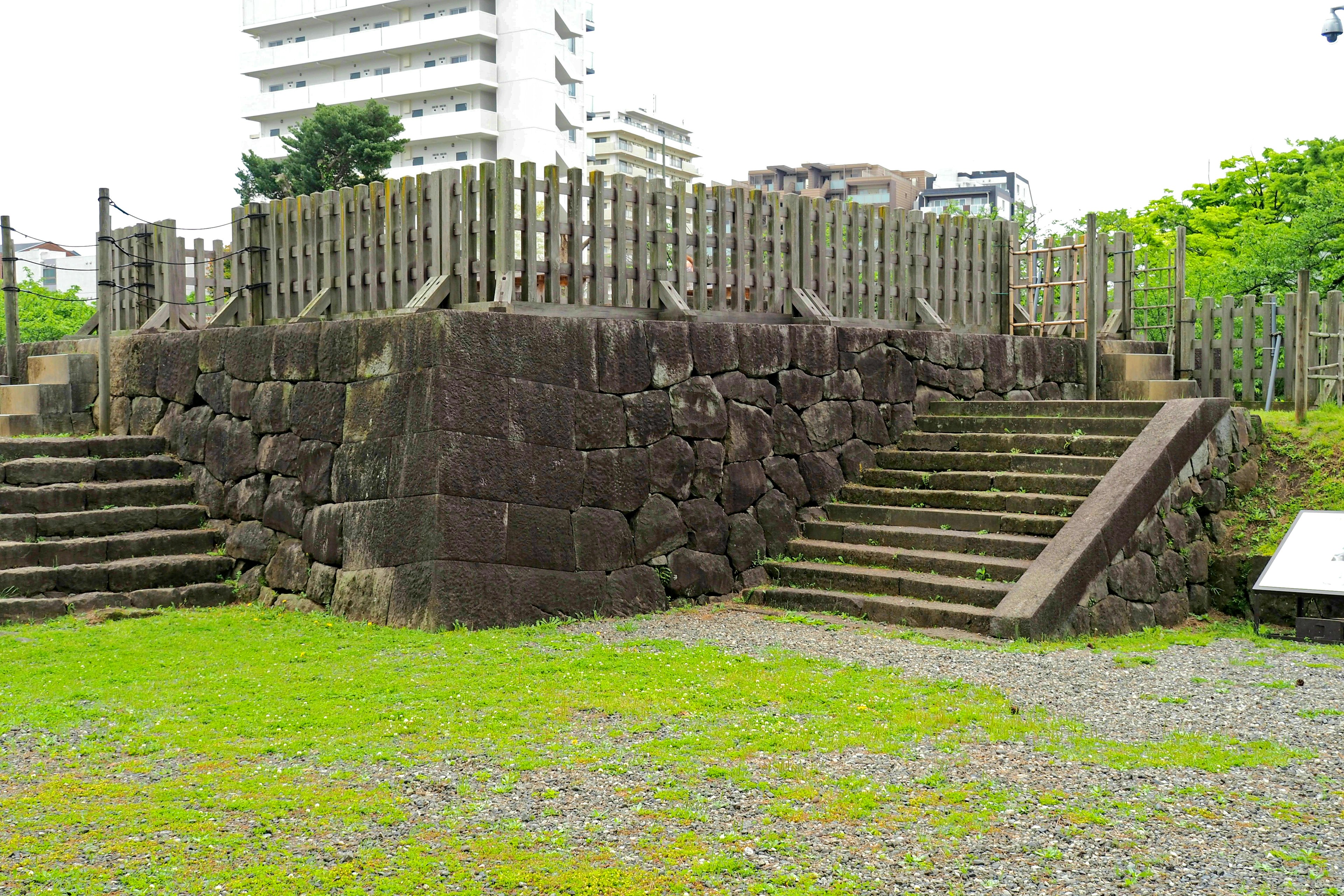 Stone structure with wooden fence in a green park