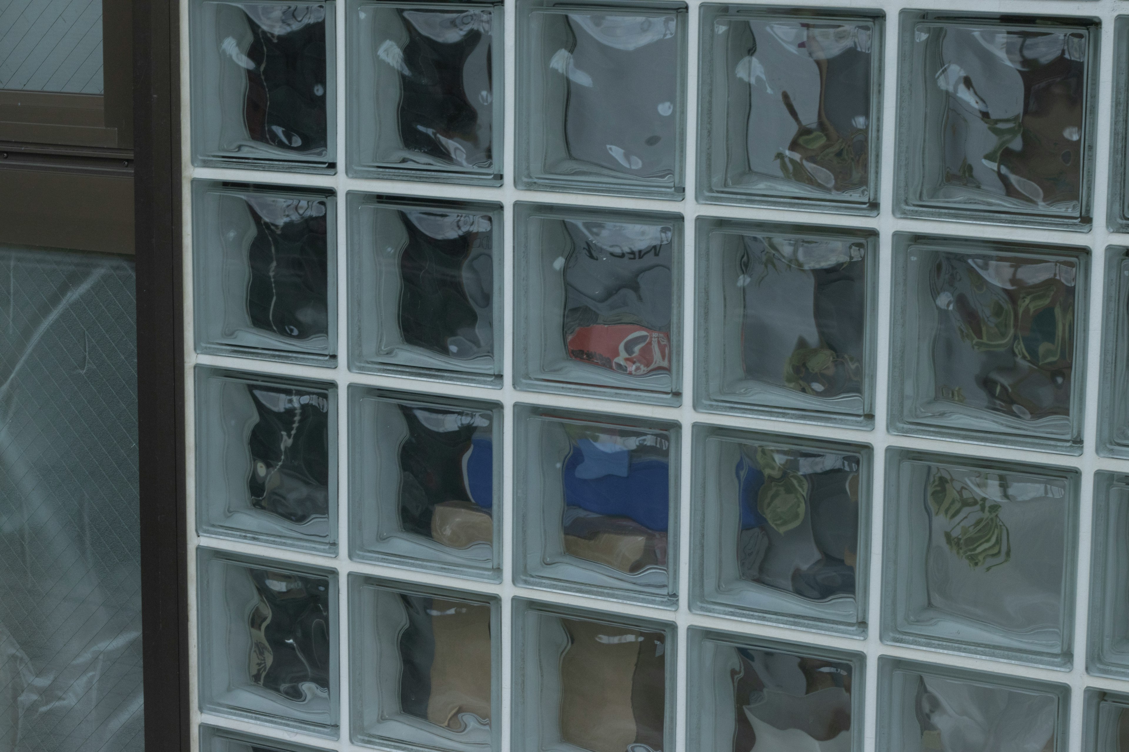 A shelf with transparent boxes containing various items