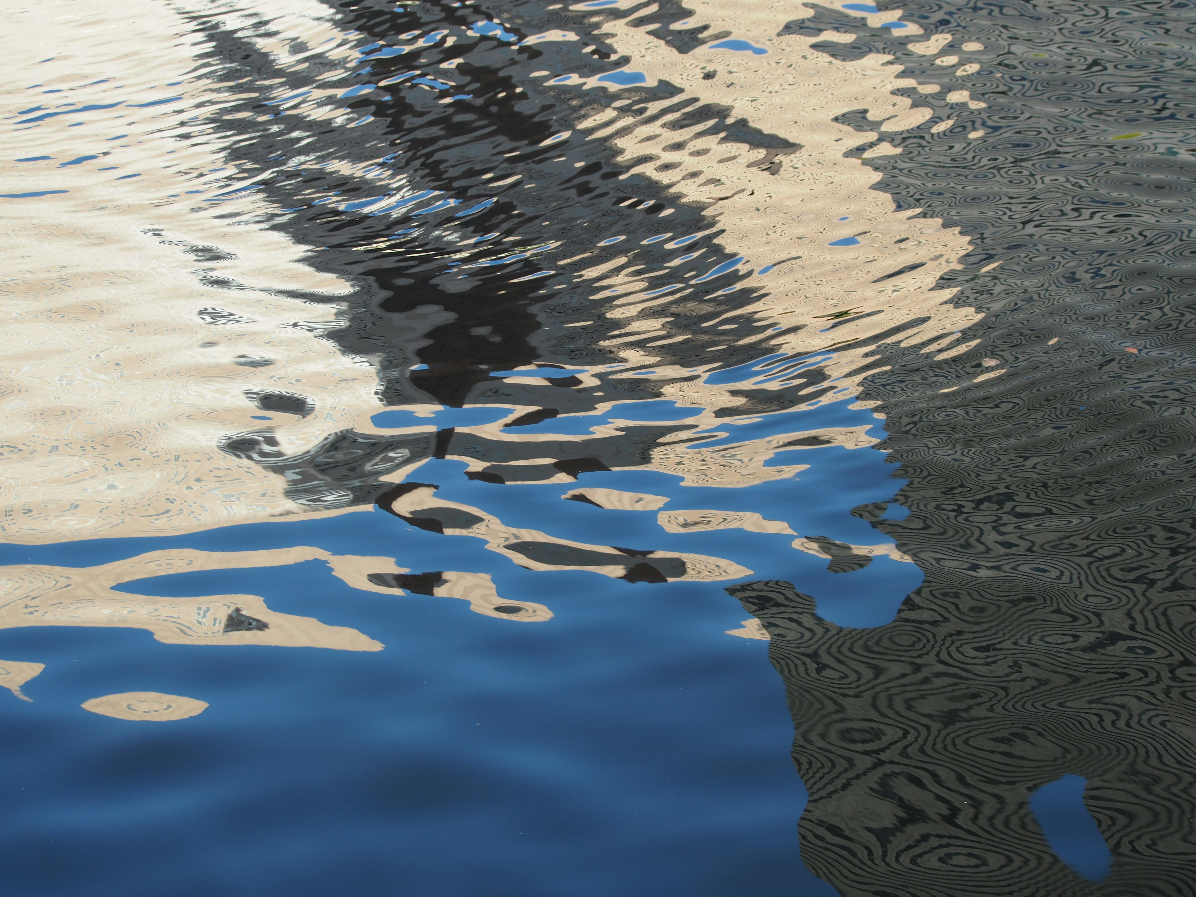 Reflection of a building on the water surface with ripples