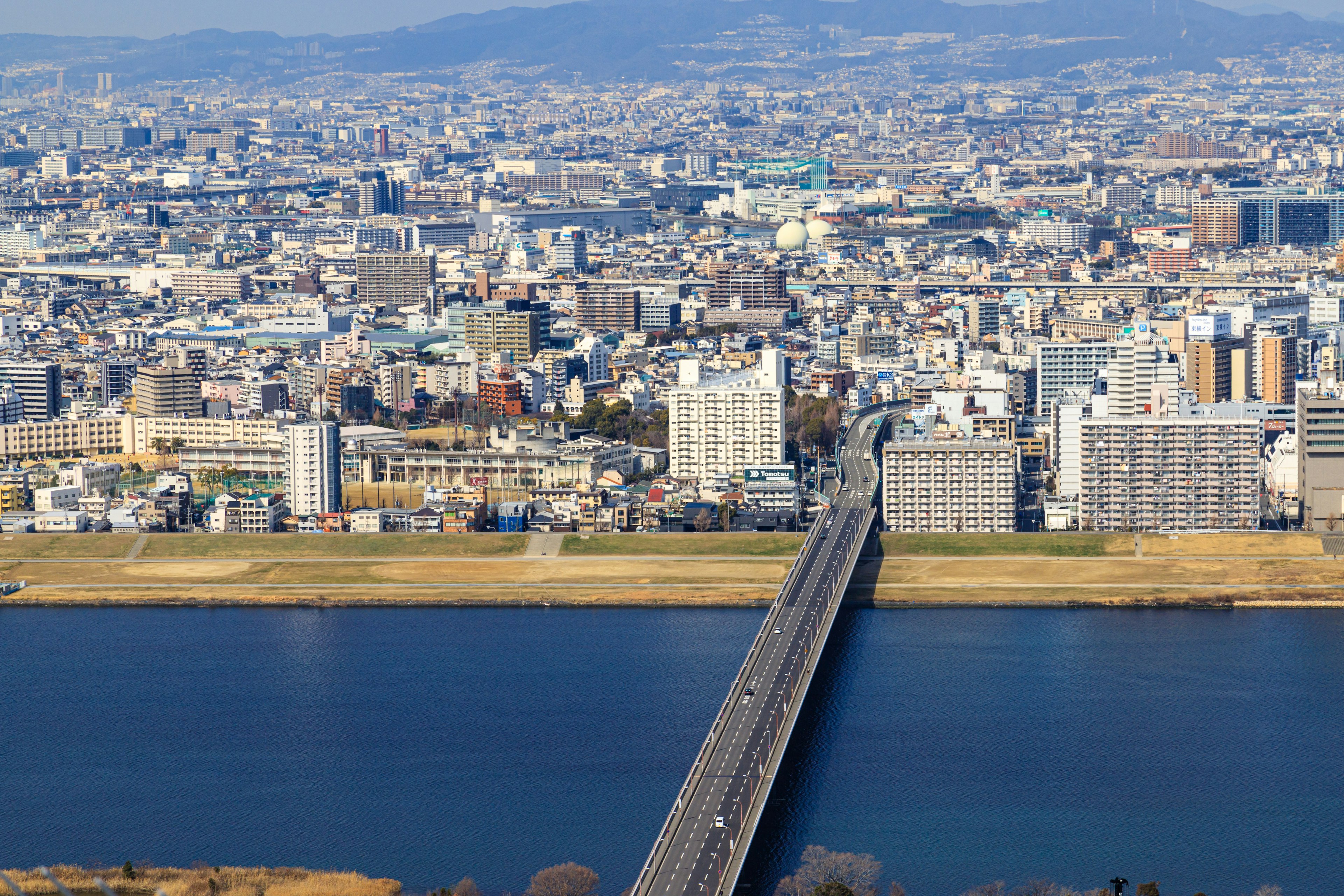 都市の広い景観と川を渡る橋を捉えた画像