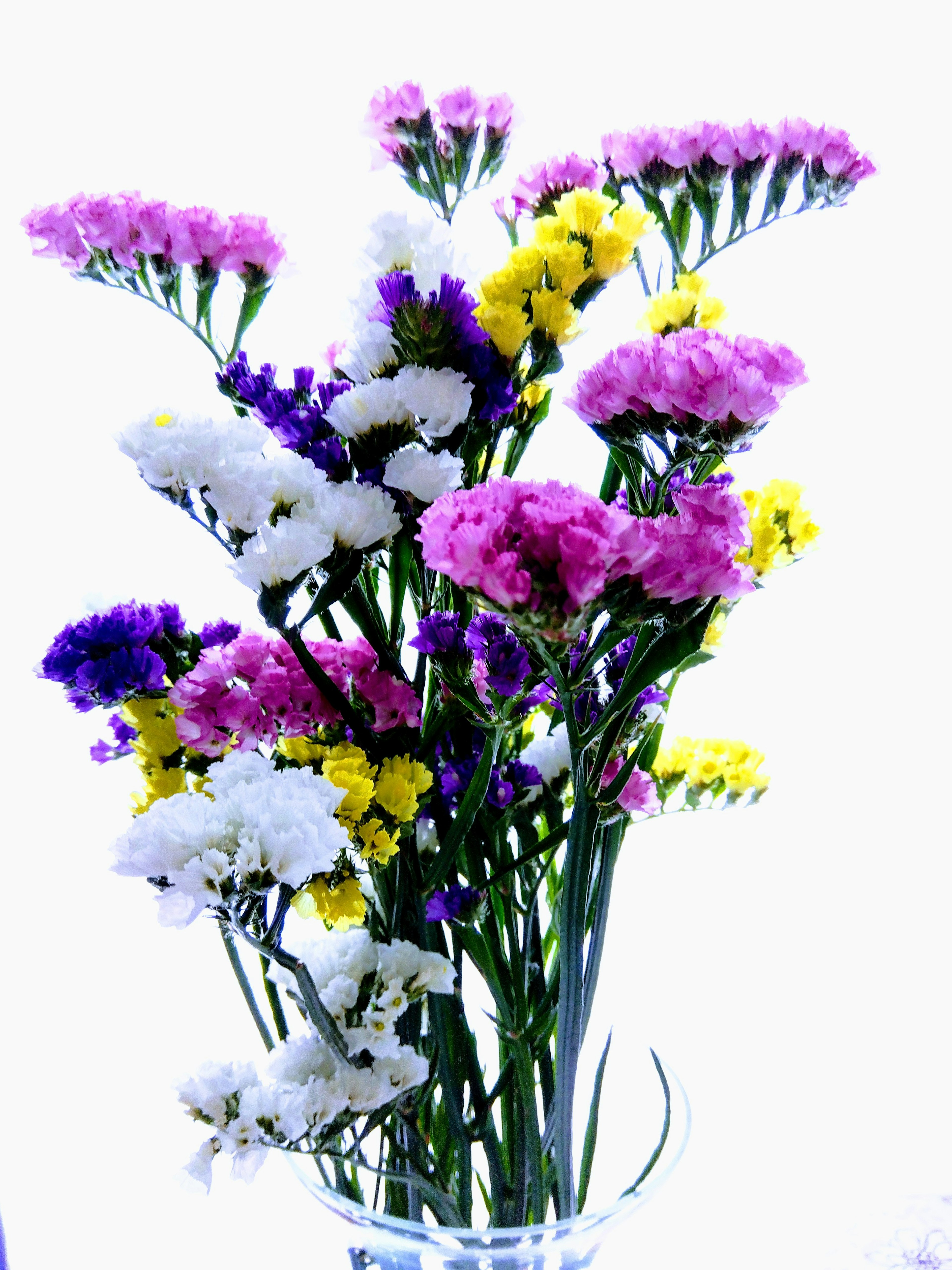 Colorful bouquet featuring white flowers purple flowers yellow flowers pink flowers