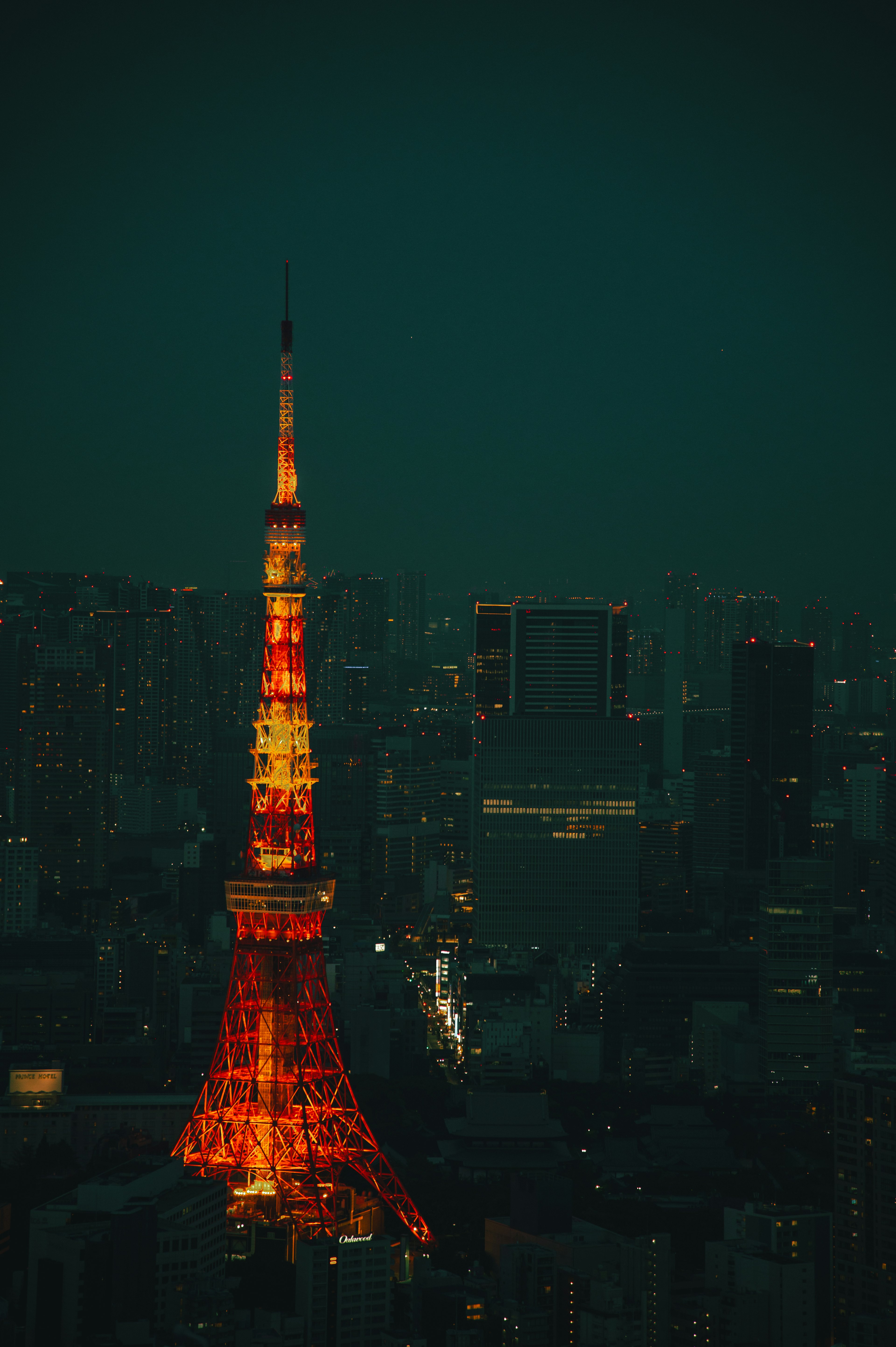 Tokyo Tower illuminated at night with a vibrant glow