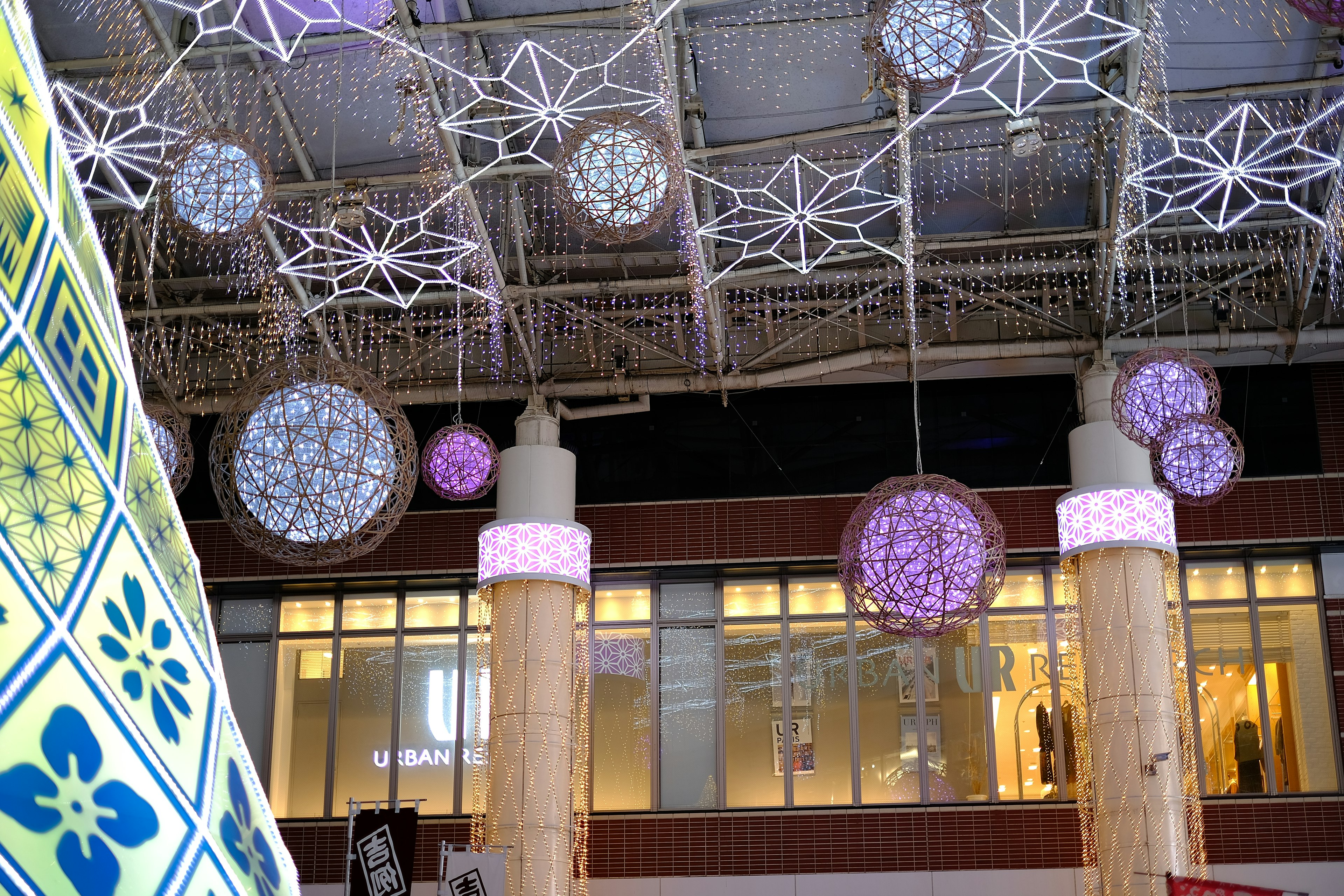 Colorful decorative lights hanging from the ceiling in a spacious area