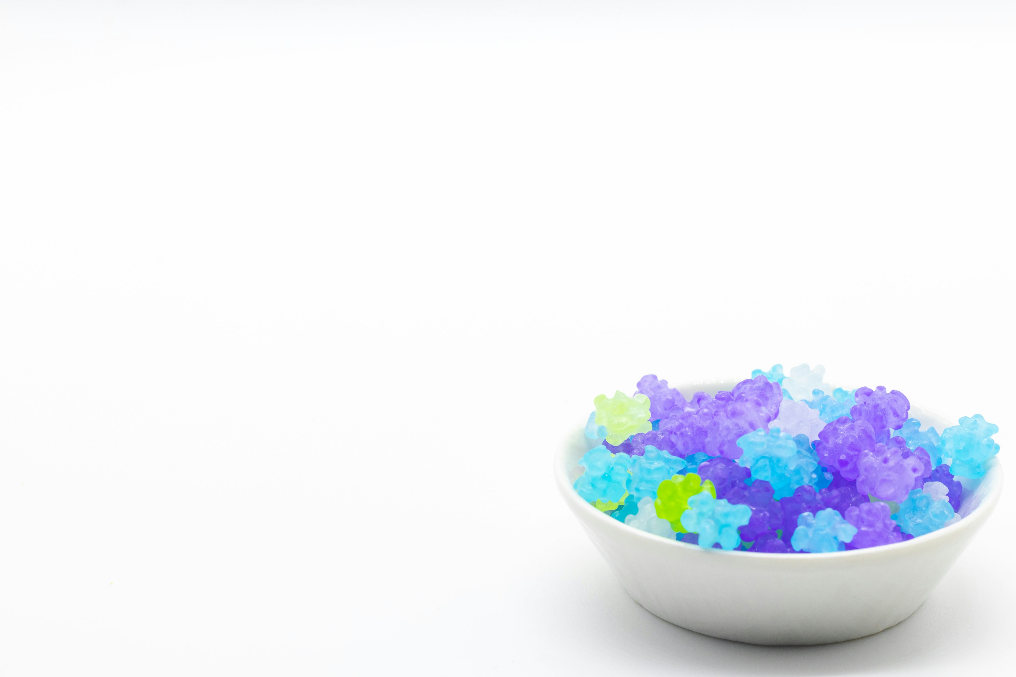 Colorful star-shaped jelly in a bowl on a white background