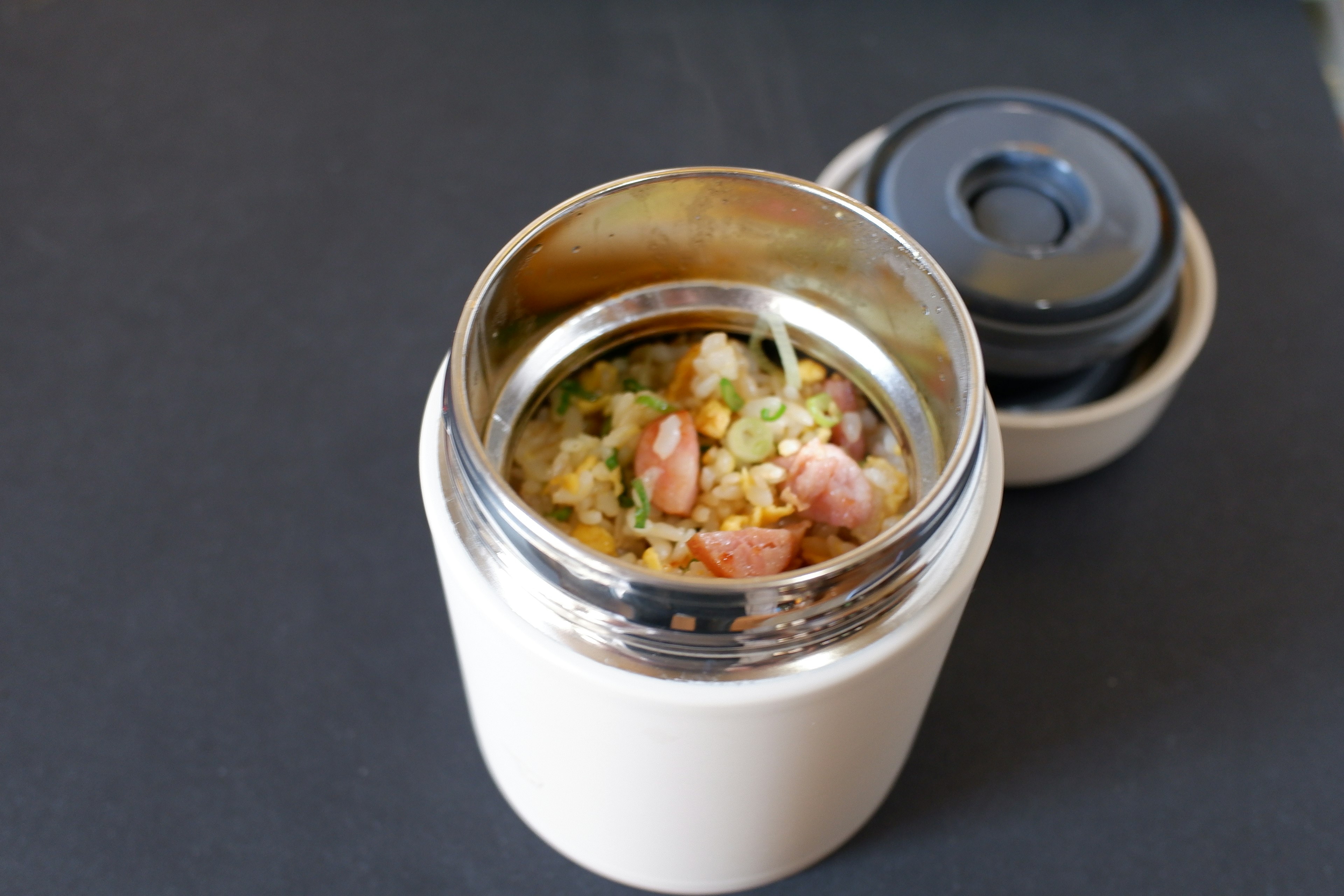 White insulated container filled with rice and ingredients