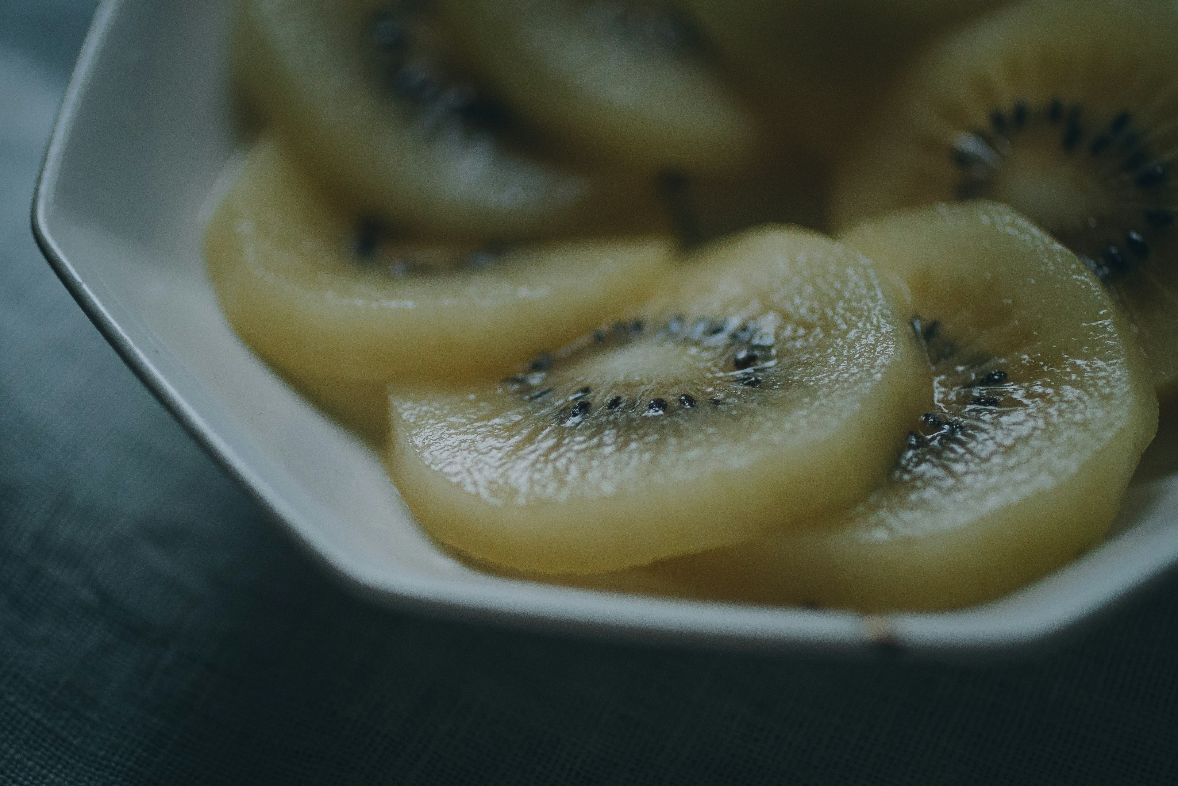 Sliced kiwi arranged in a white dish