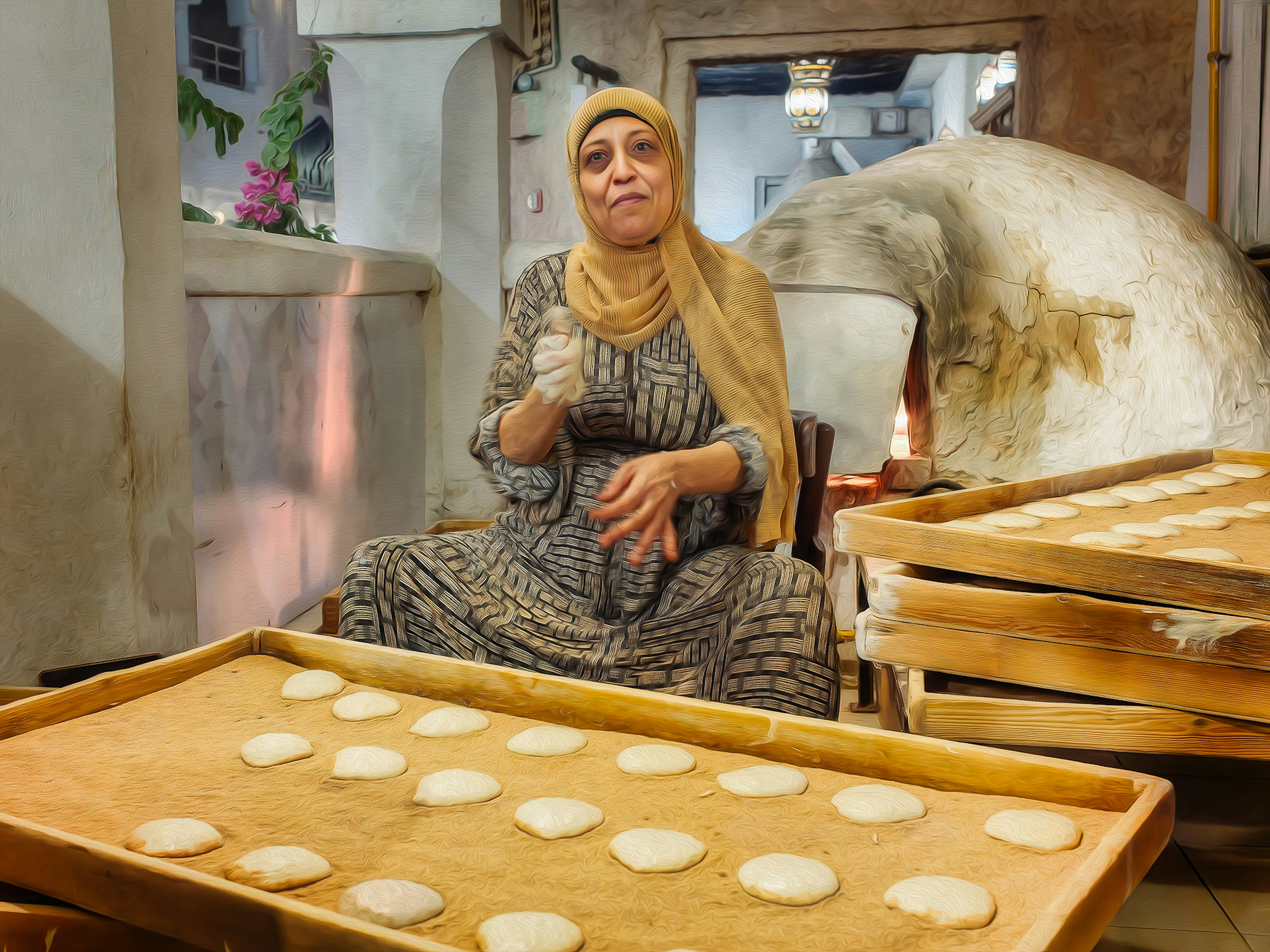 Una mujer con atuendo tradicional preparando masa en una panadería