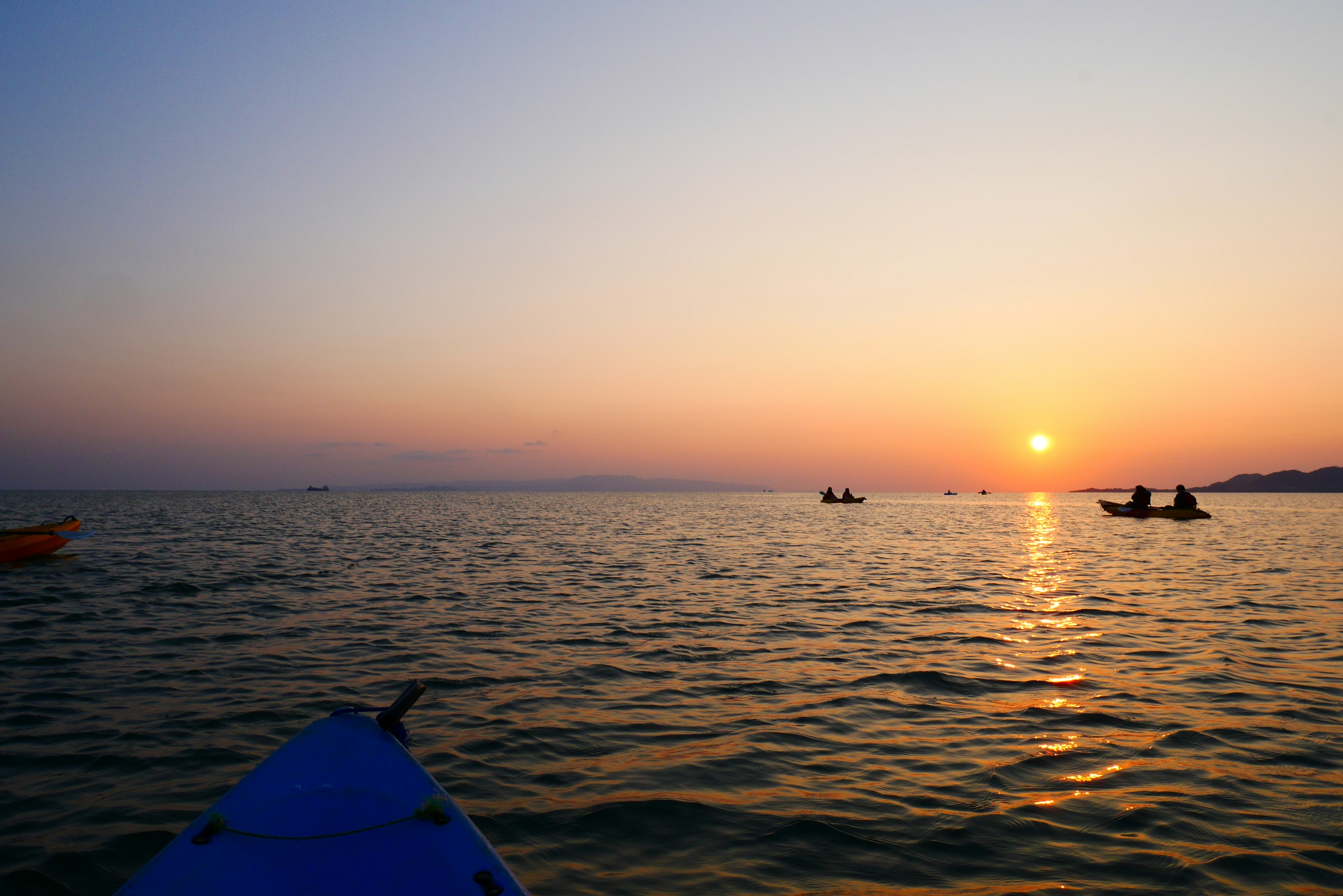 Kayakers on the sea during a beautiful sunset