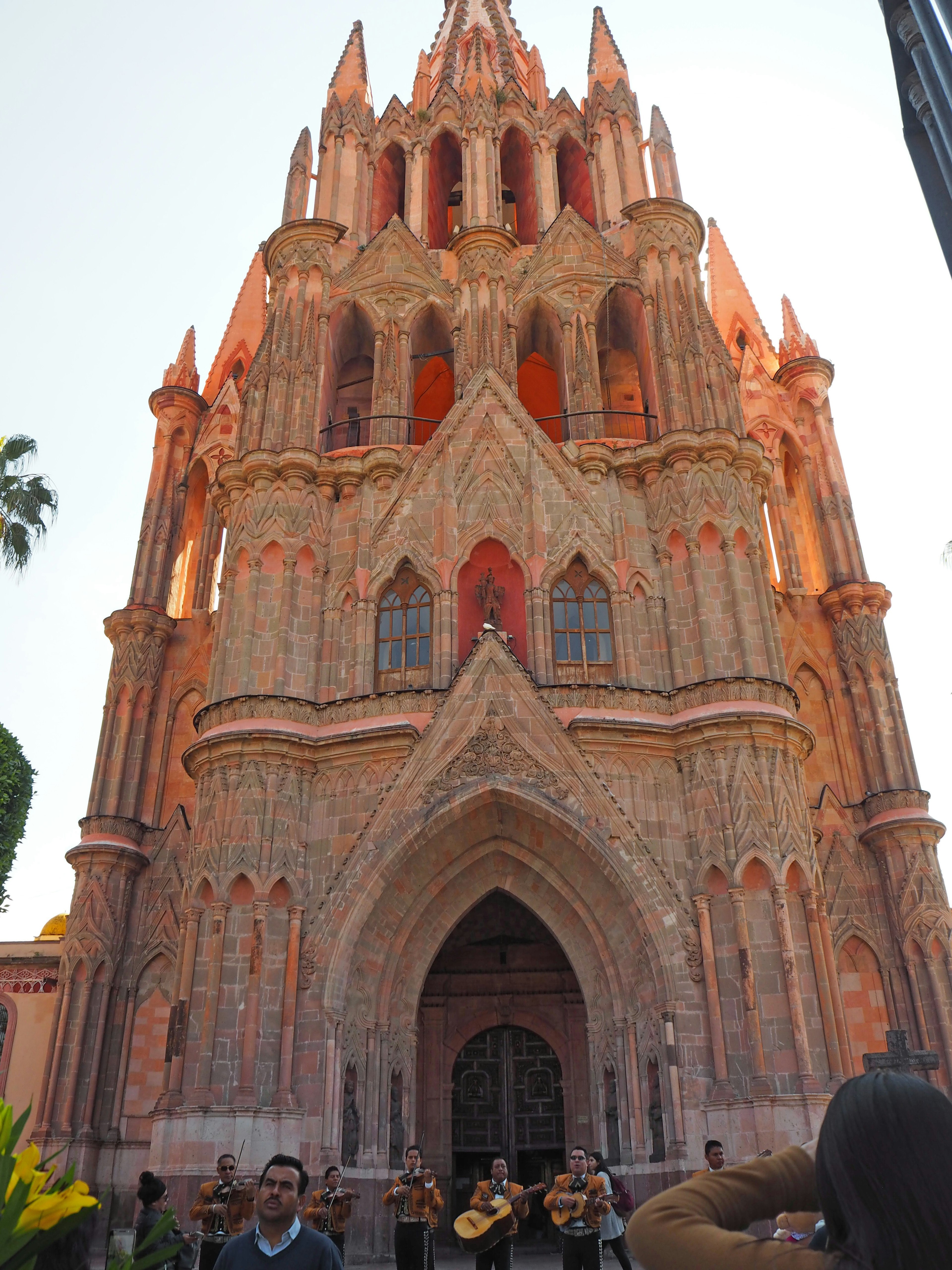 Tampilan luar gereja yang indah di San Miguel de Allende dengan musisi