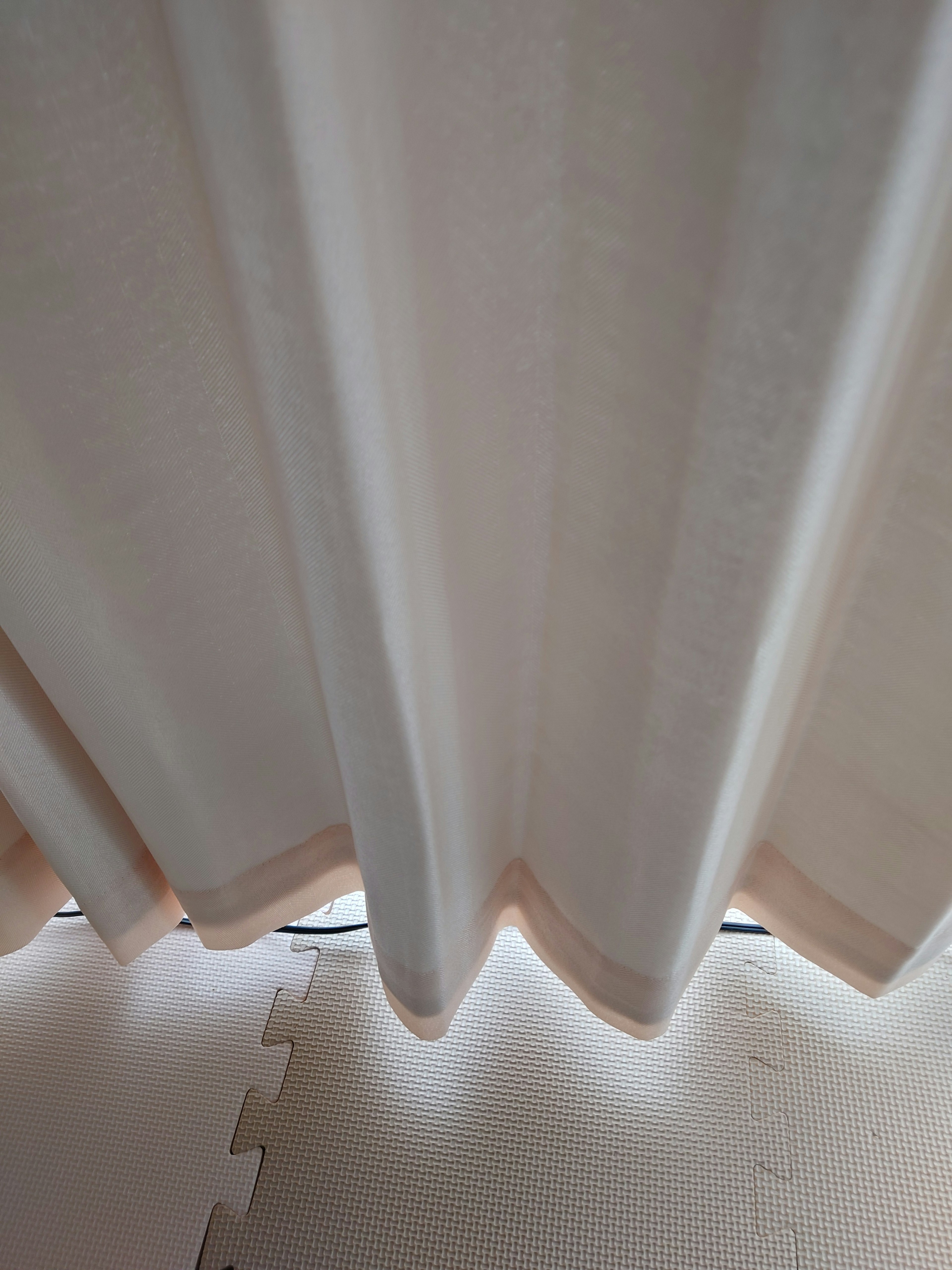 Soft fabric curtains gently draping with light filtering through