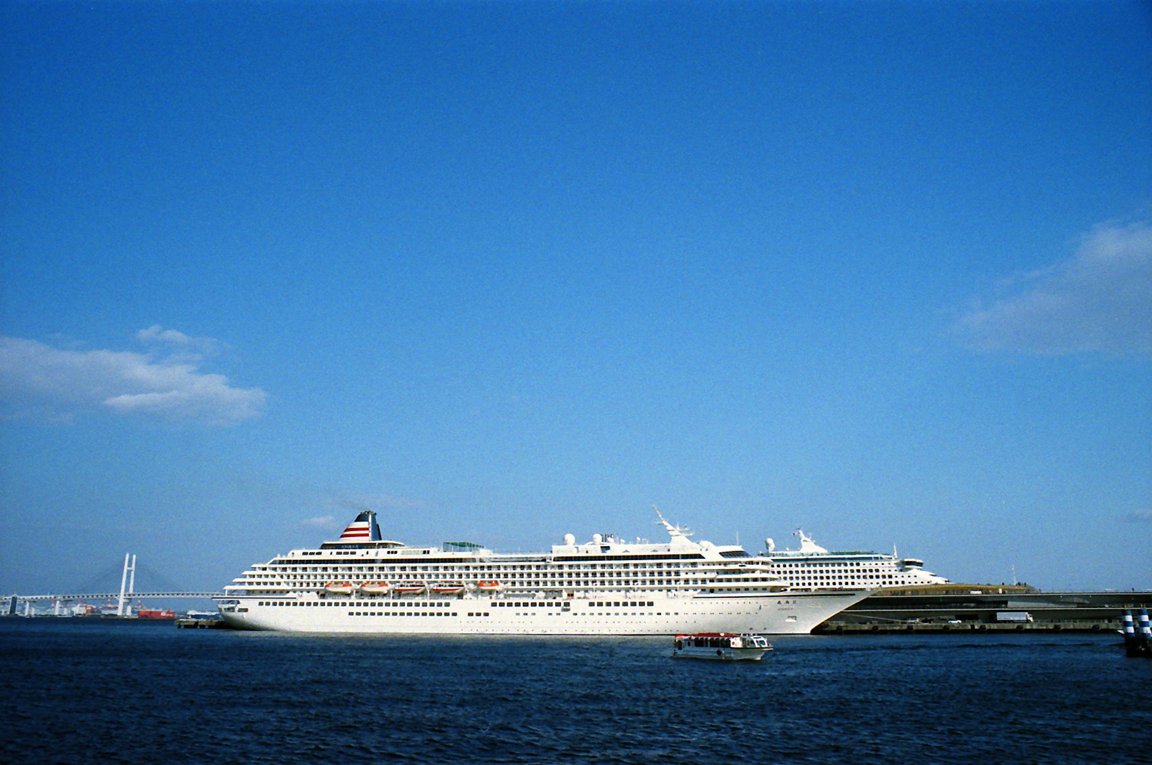 A luxurious cruise ship floating under a blue sky