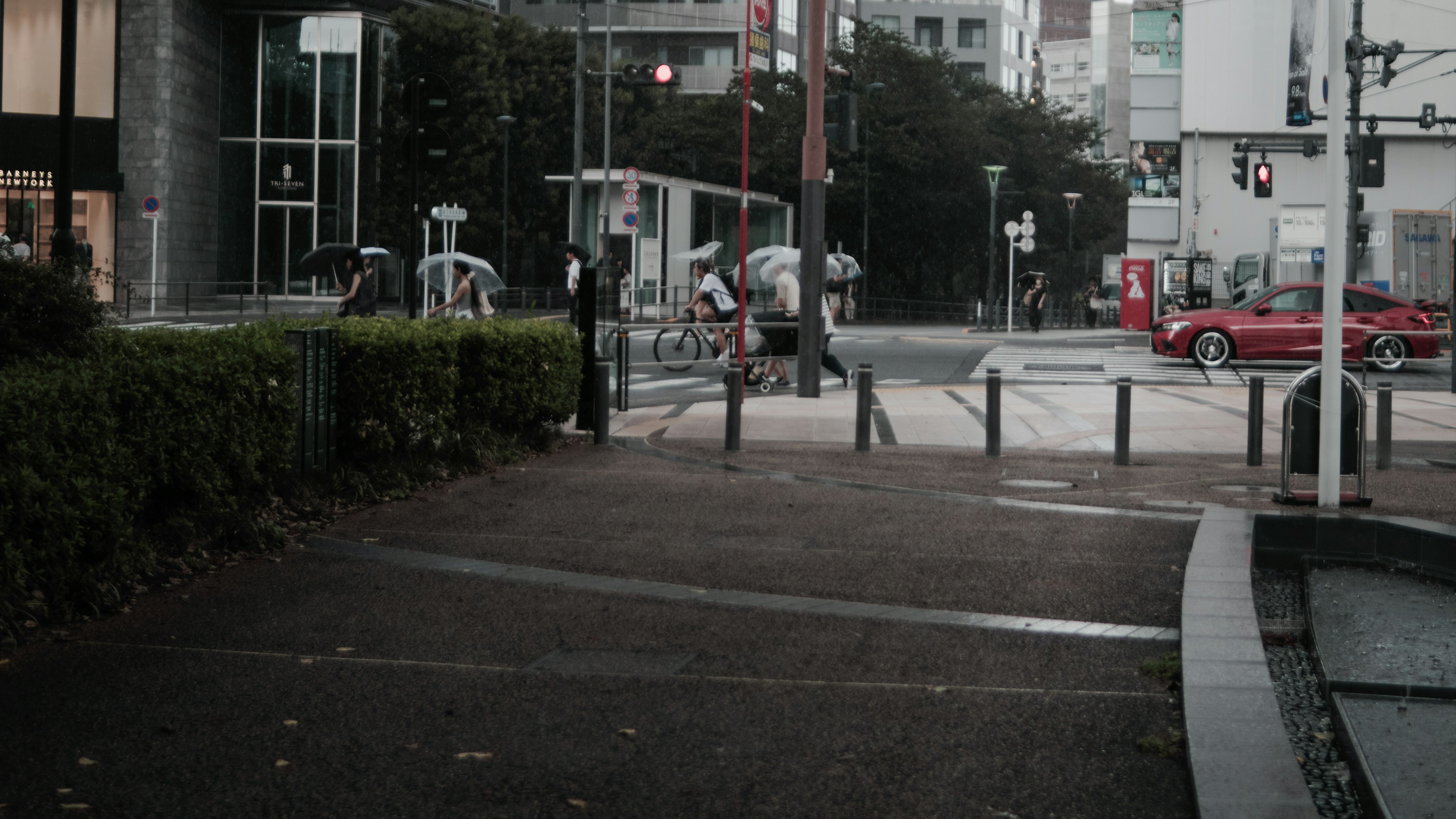 Pedestrians waiting at a traffic light in an urban intersection