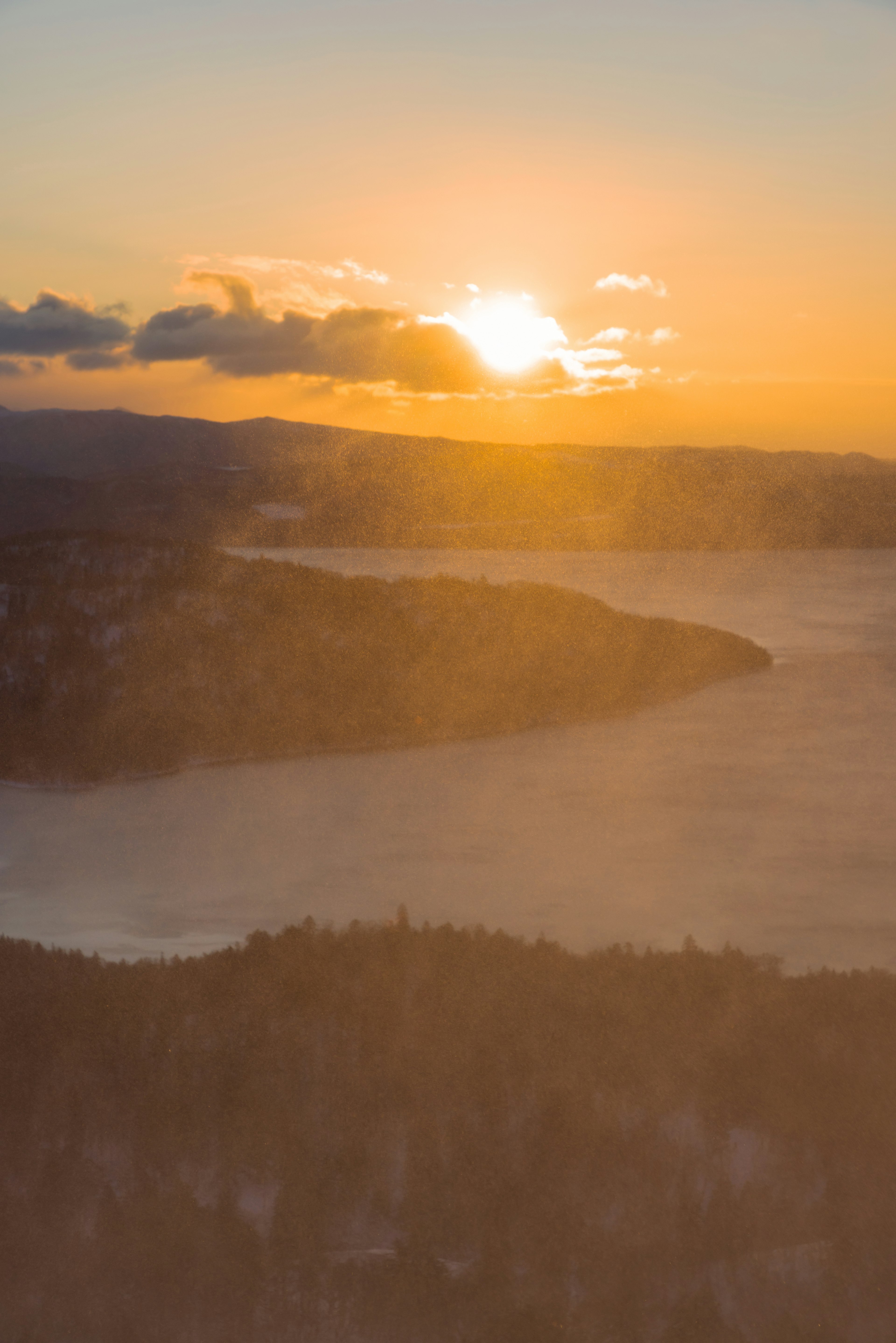 Sunset over a lake with distant hills