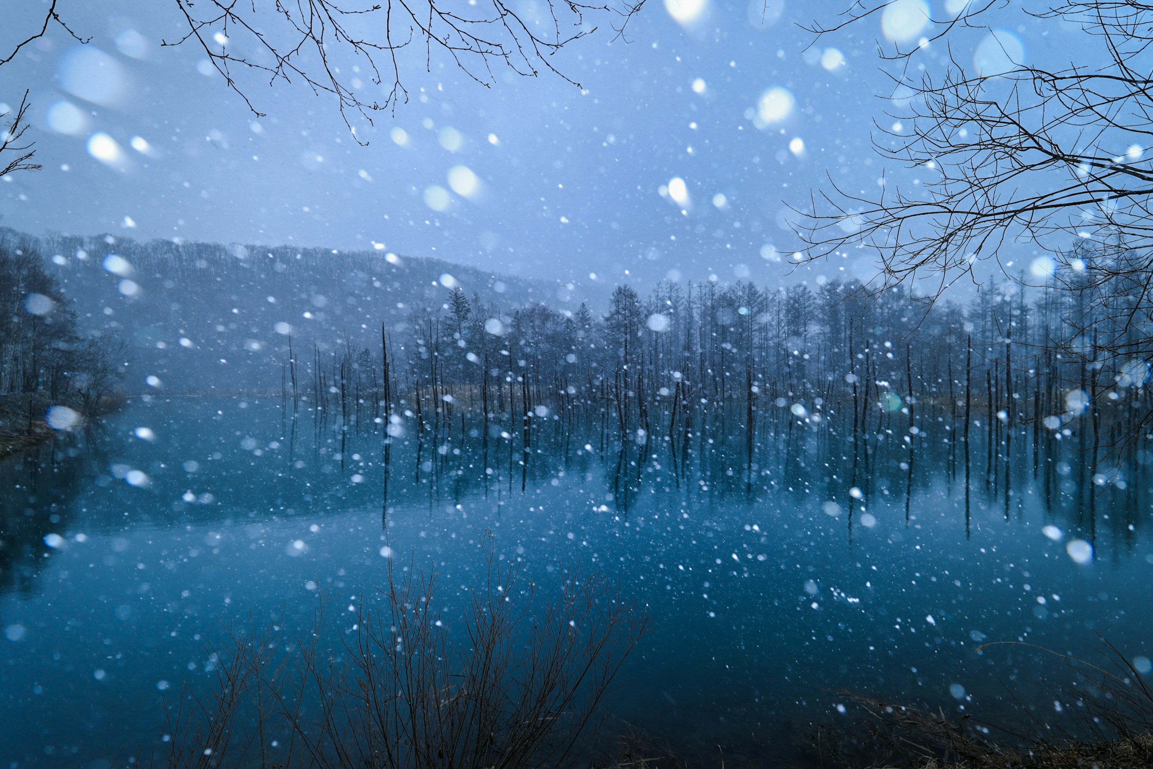 Peaceful lake scene with falling snow