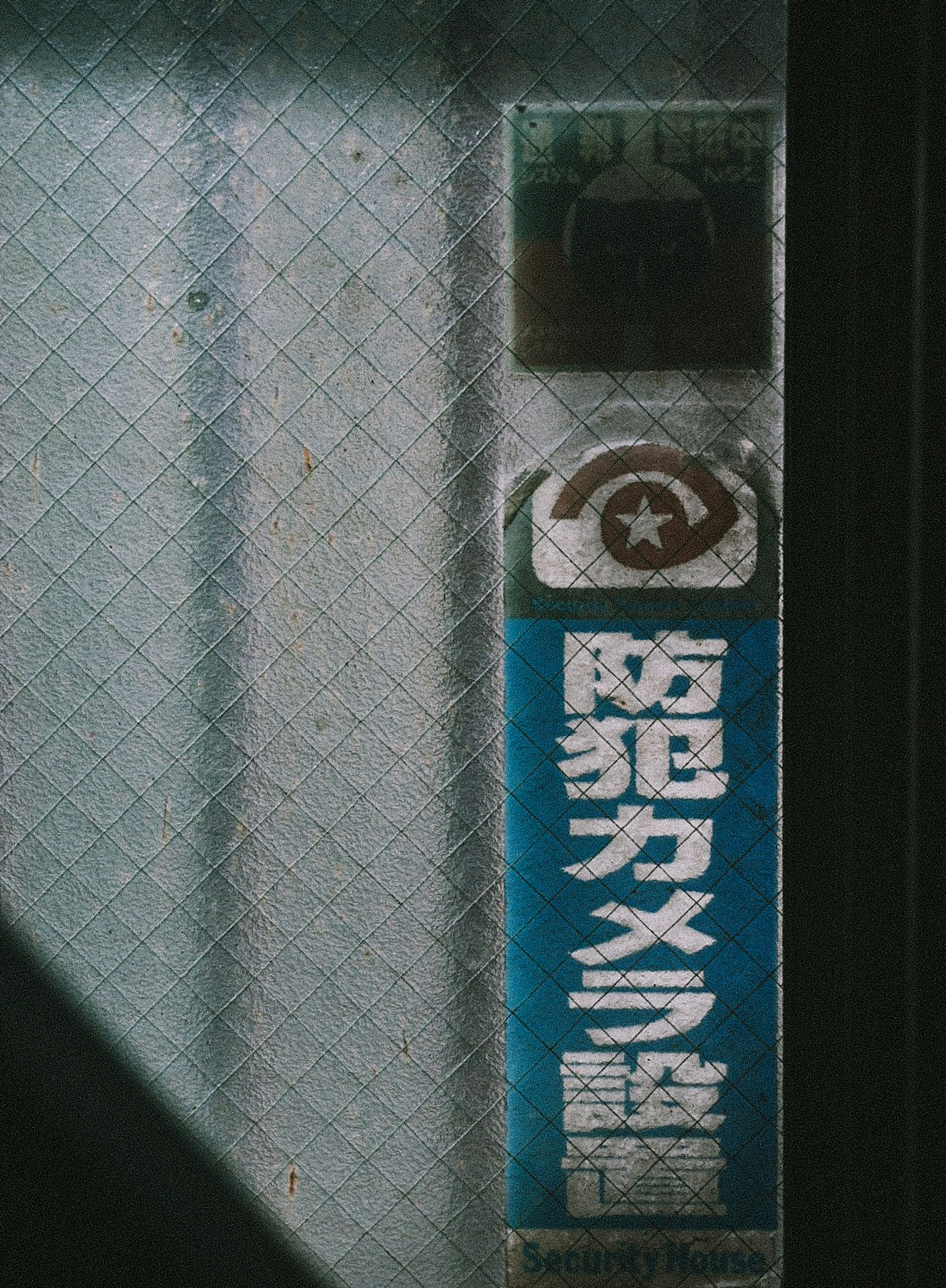 Blue security camera sign with window background