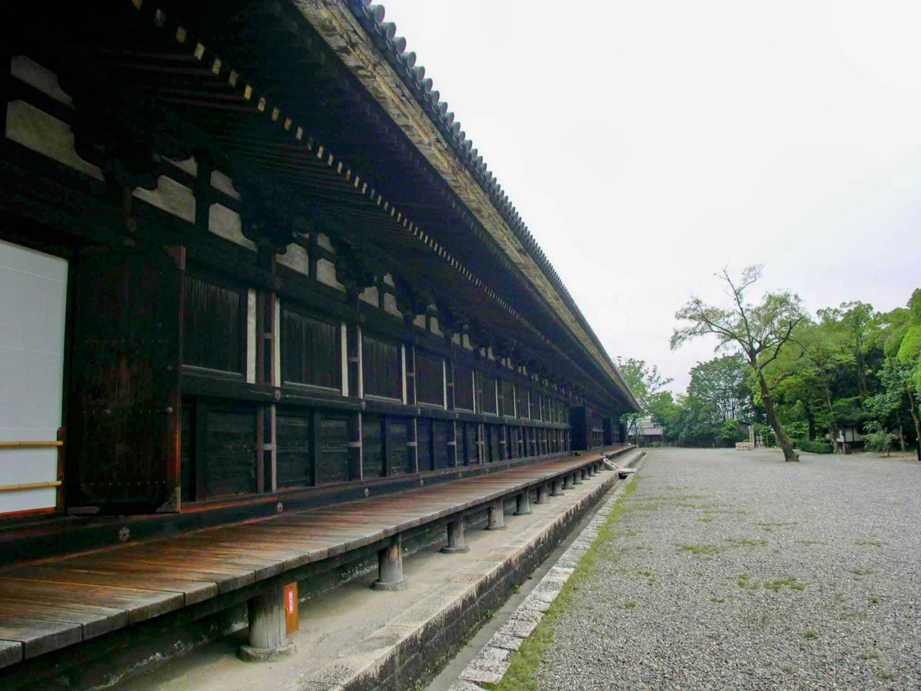 Exterior view of a wooden temple with a serene garden