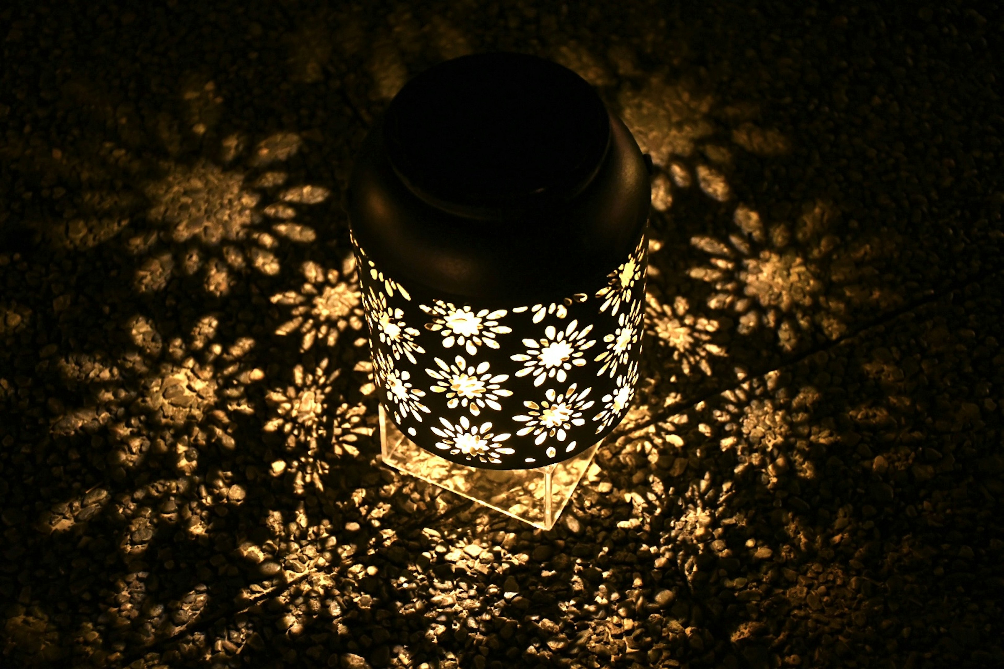 A beautiful floral-patterned lantern glowing in the darkness