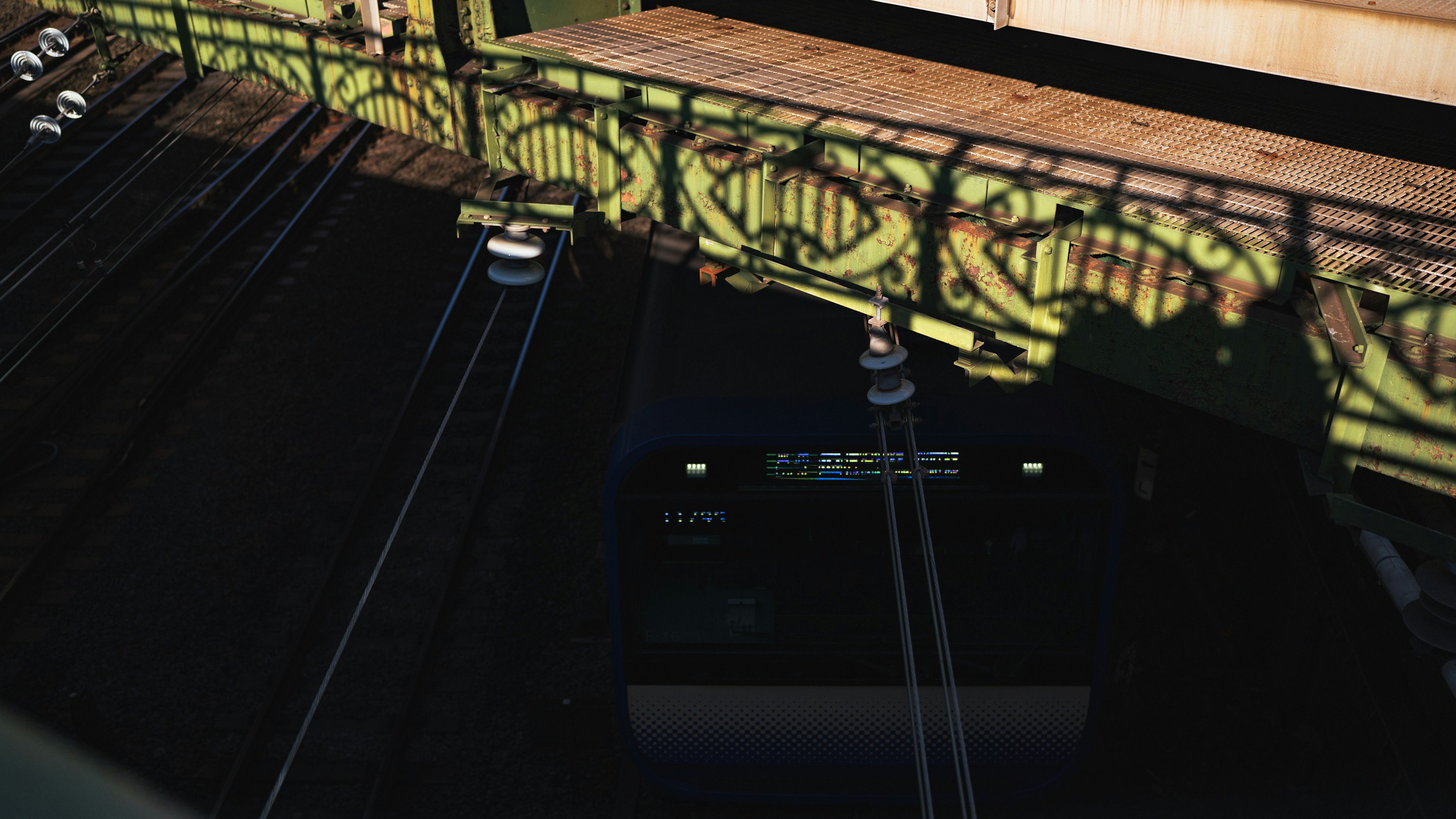 Dark water surface beneath a bridge with decorative railing