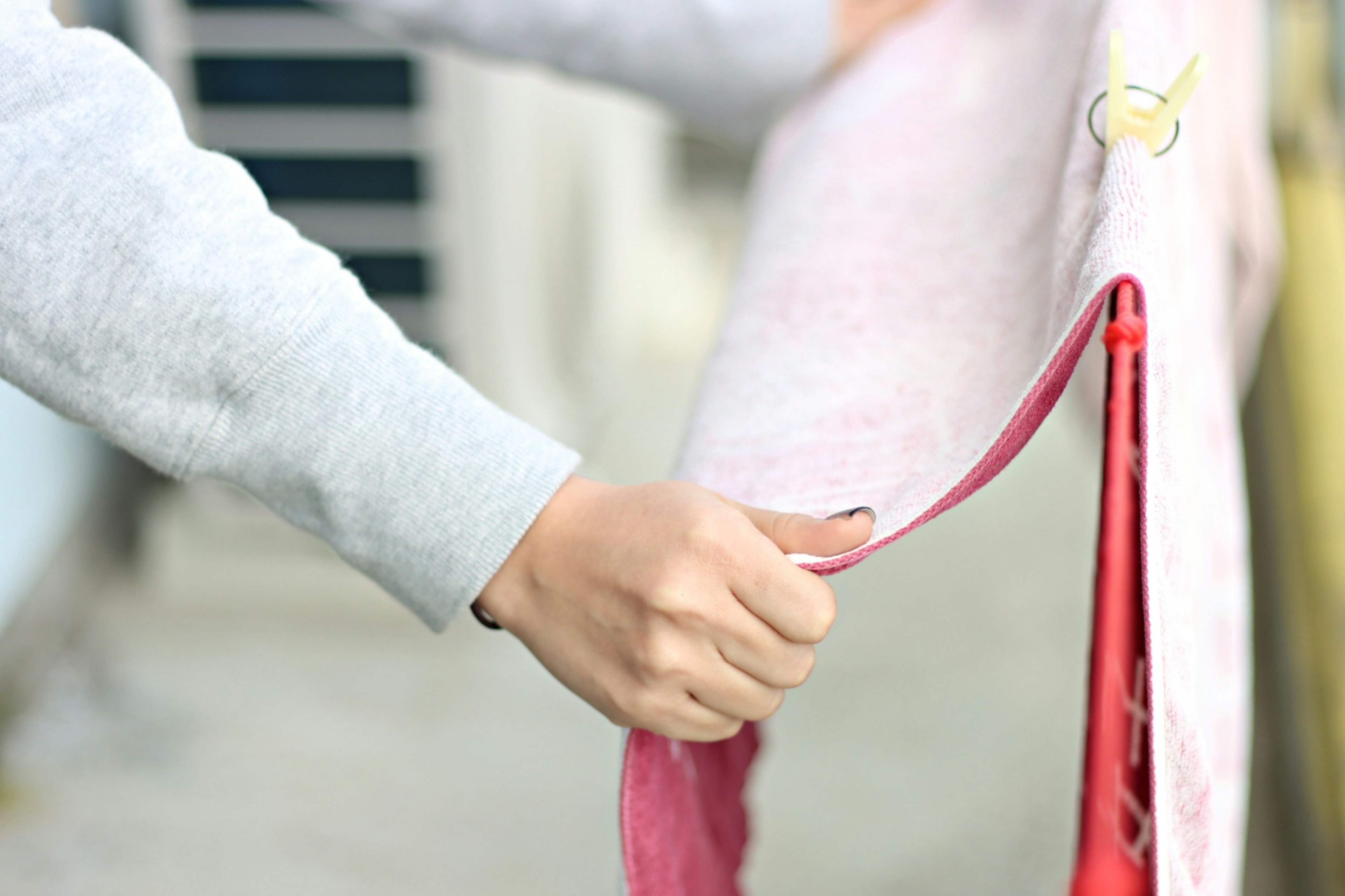 Close-up of a person holding a pink towel