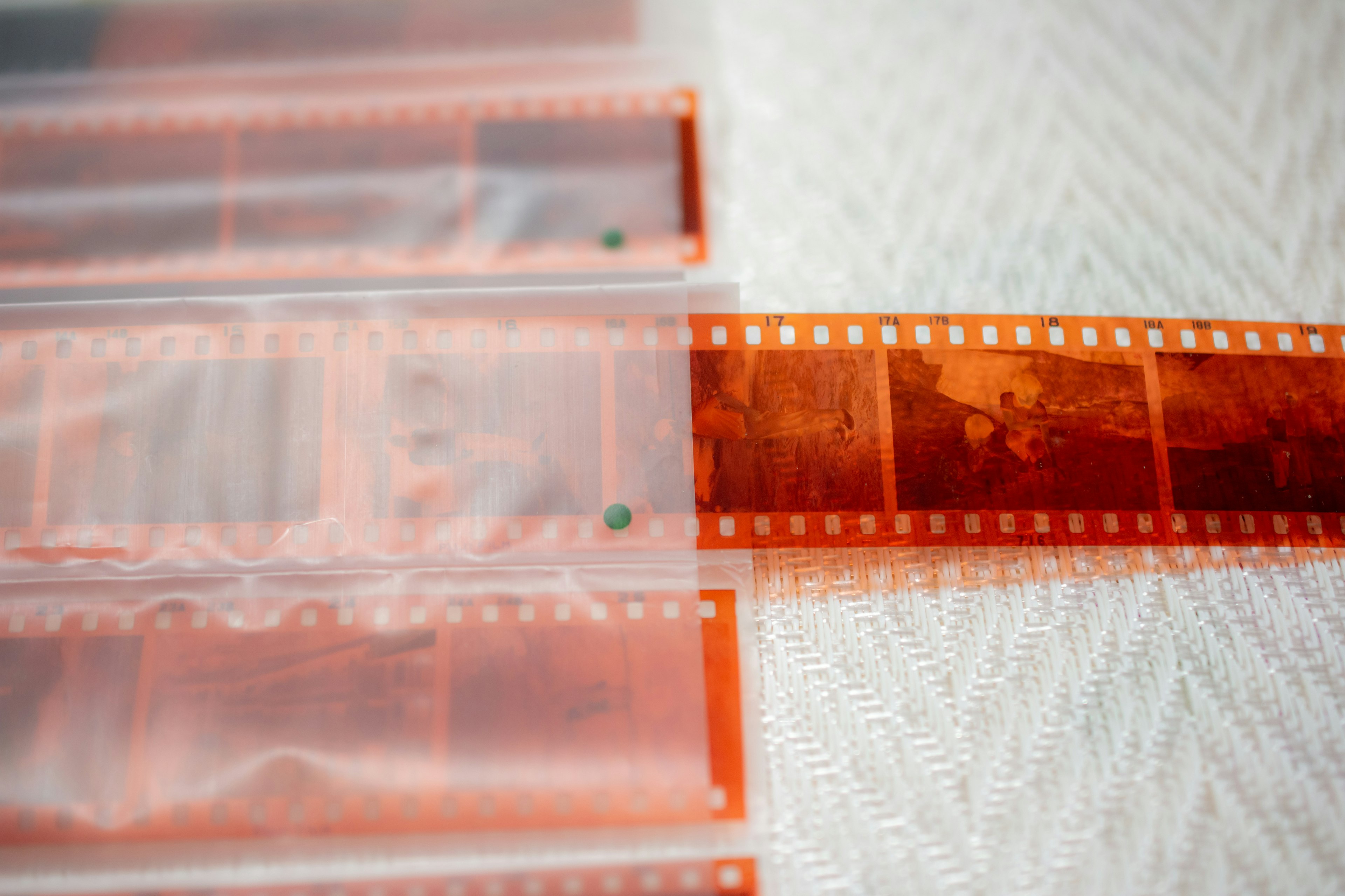 A section of film visible in orange film sleeves