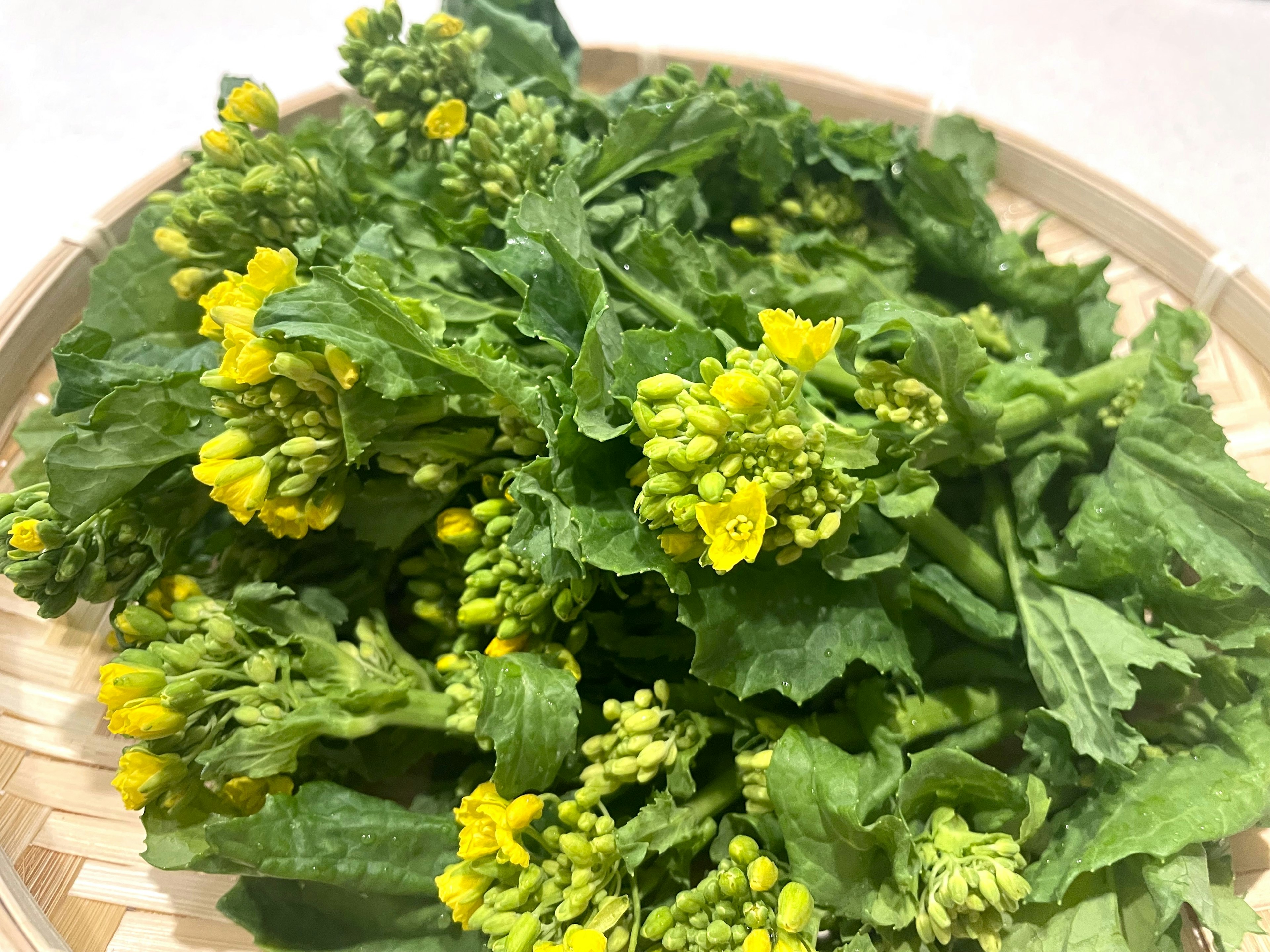 A bunch of greens with yellow flowers