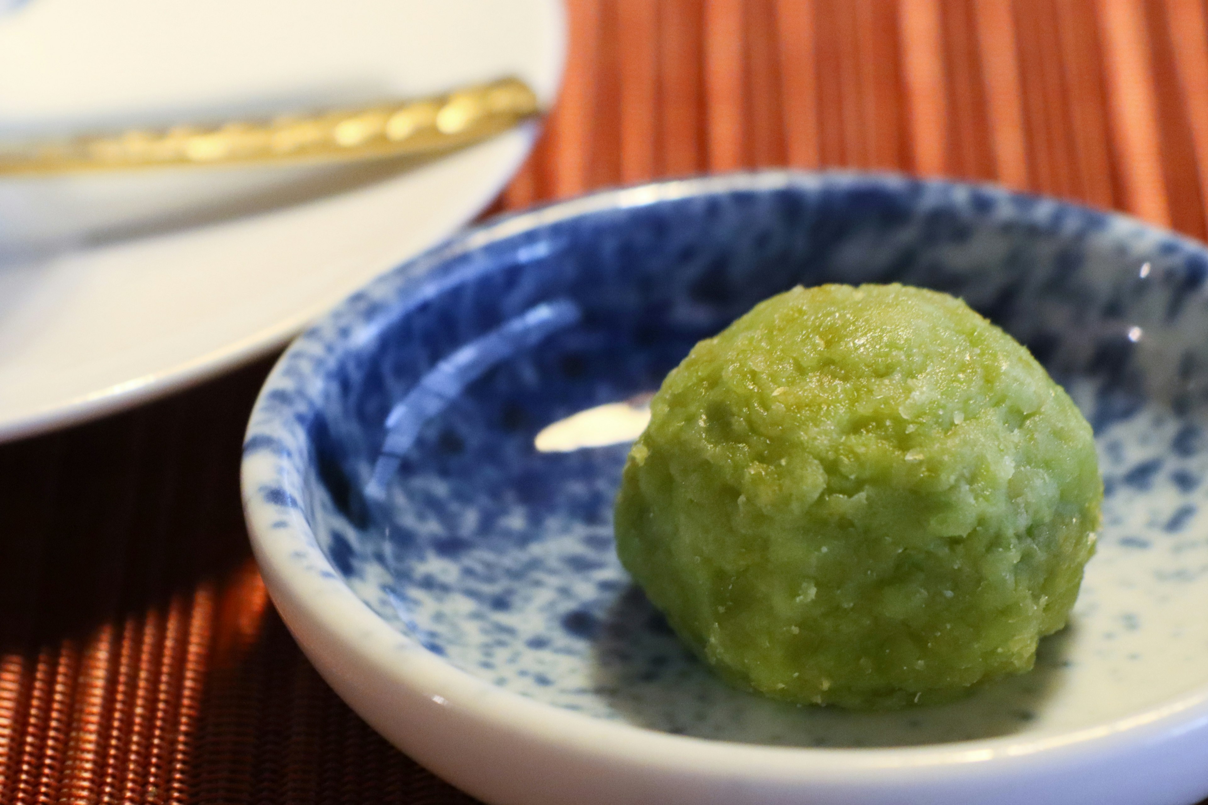 Green Japanese confection placed on a white dish