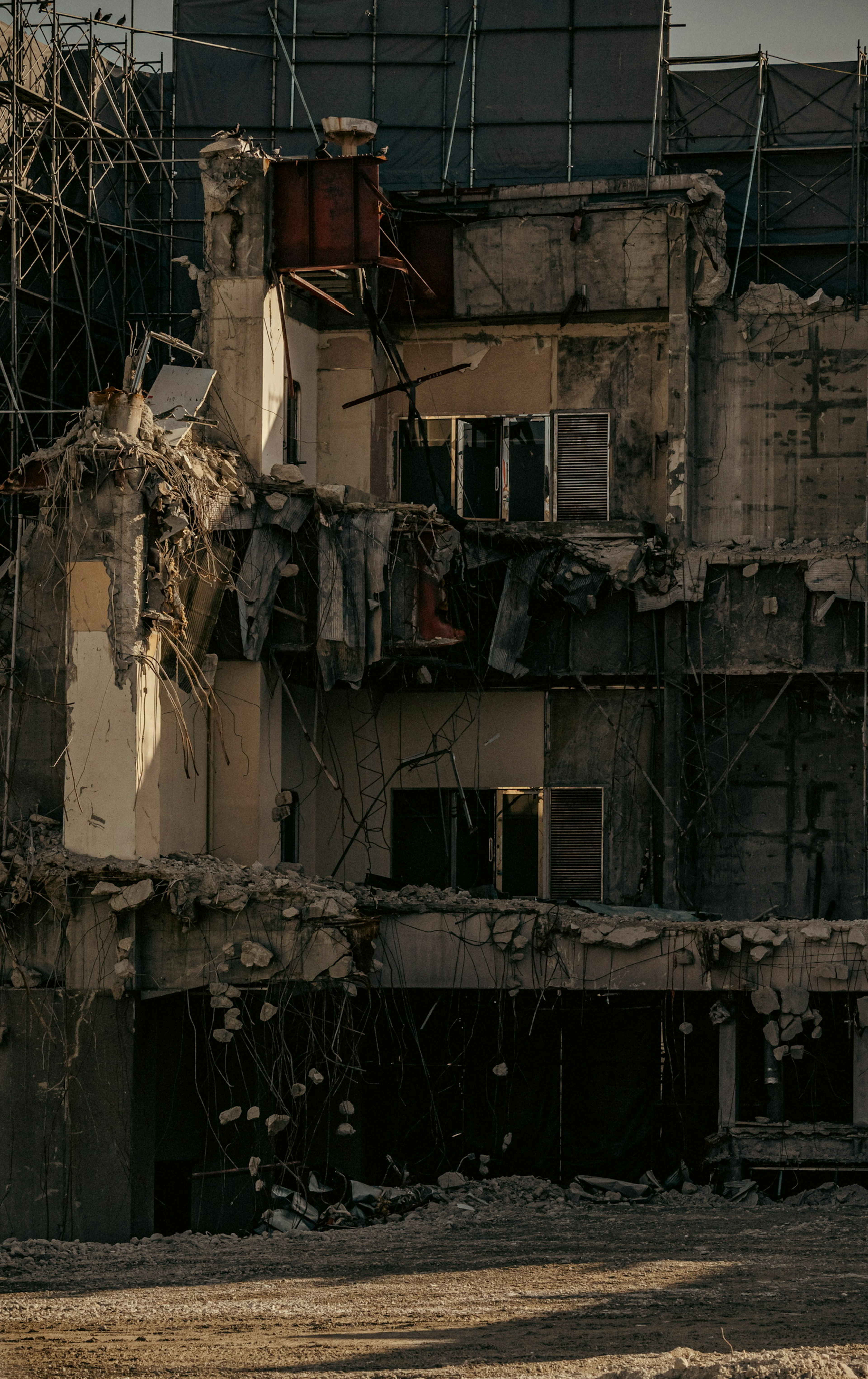 Exterior of a collapsed building with damaged walls and windows