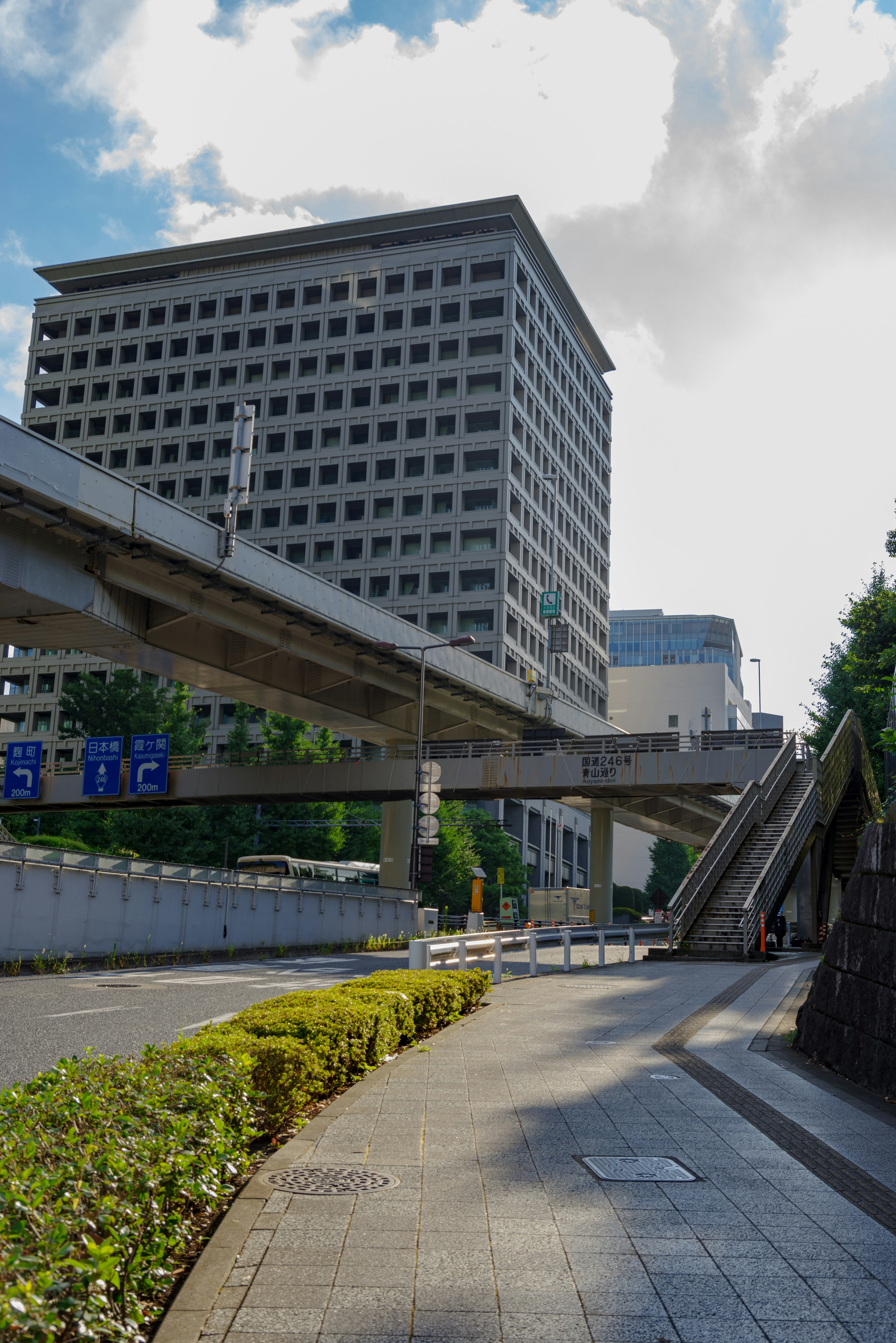 Urban landscape featuring a high-rise building and elevated roadway