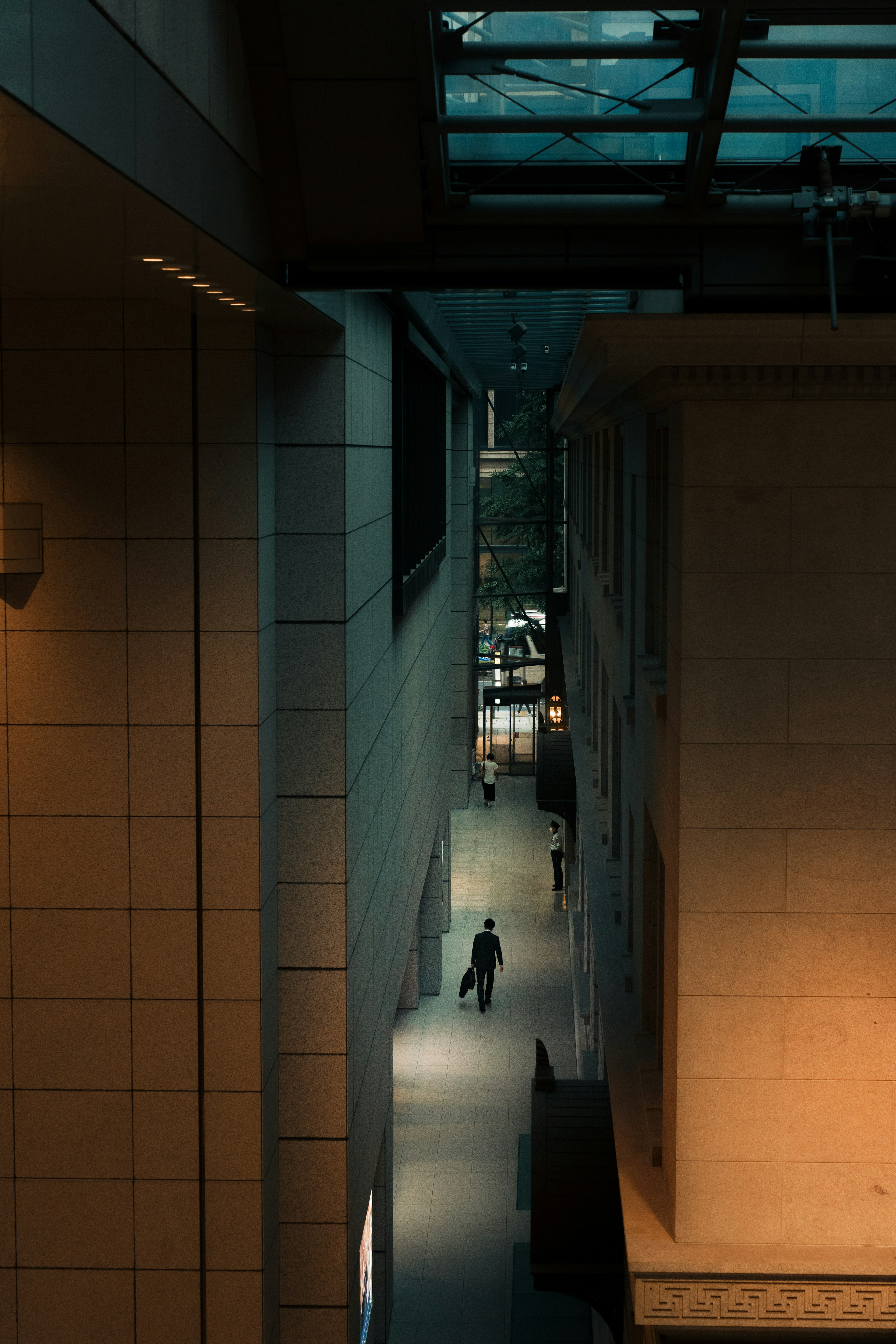 Night urban scene with a person walking in a narrow alley