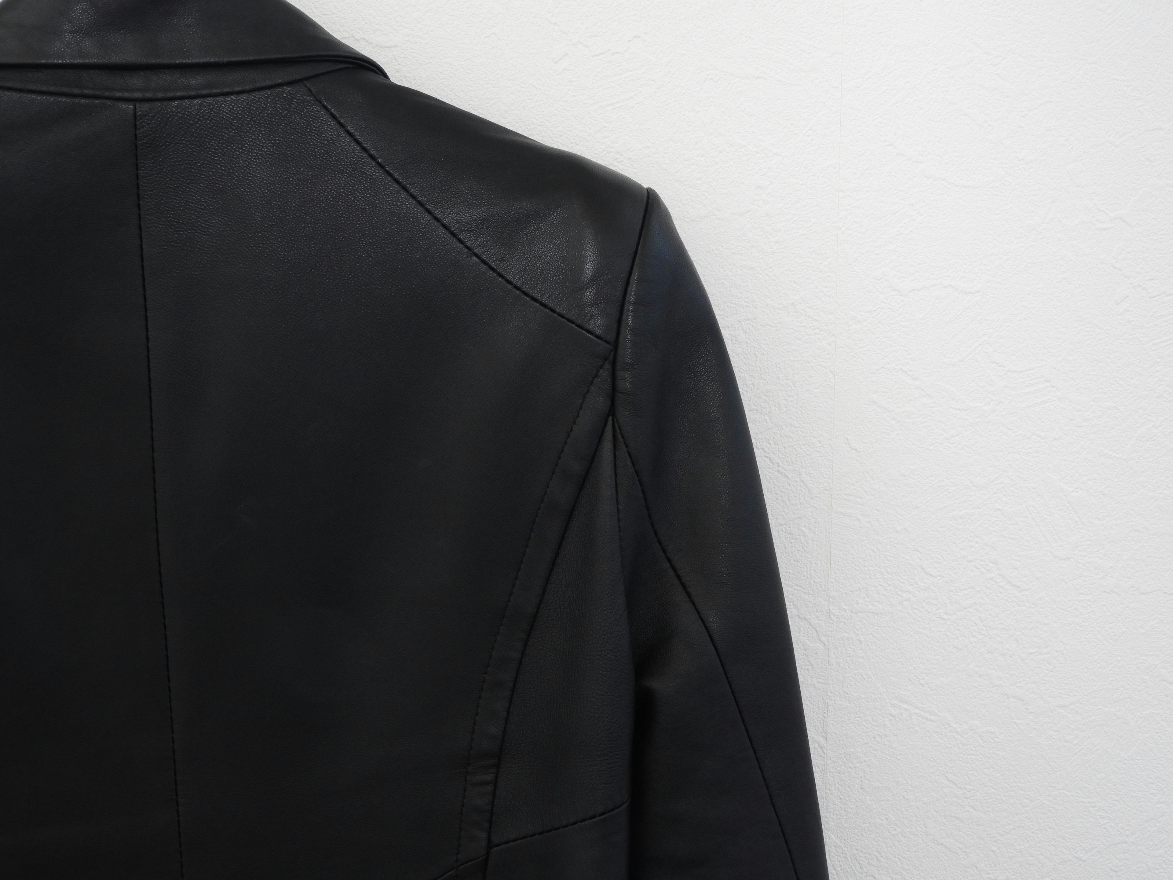 Detail of the back of a black leather jacket