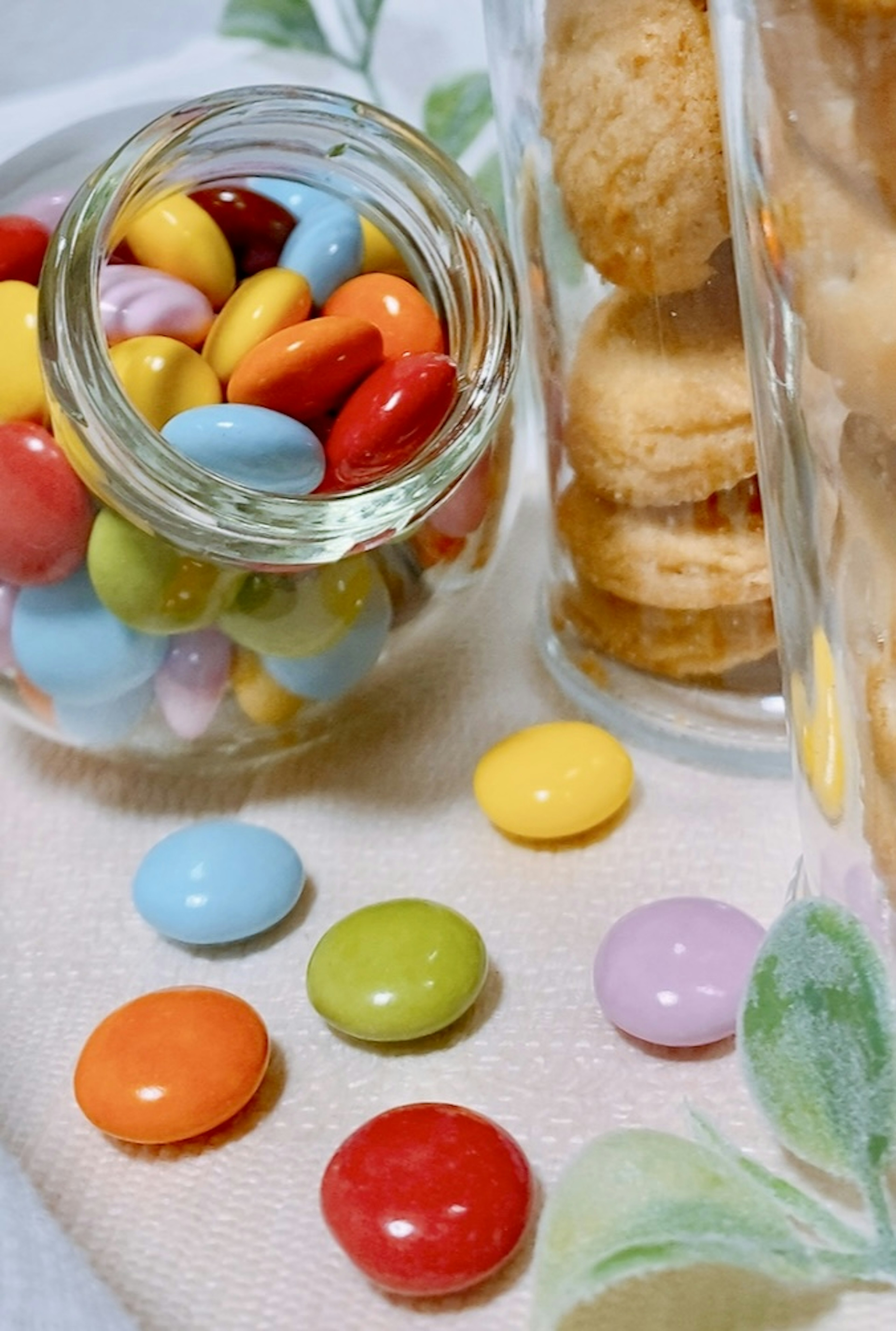 Colorful candies and cookies displayed in jars