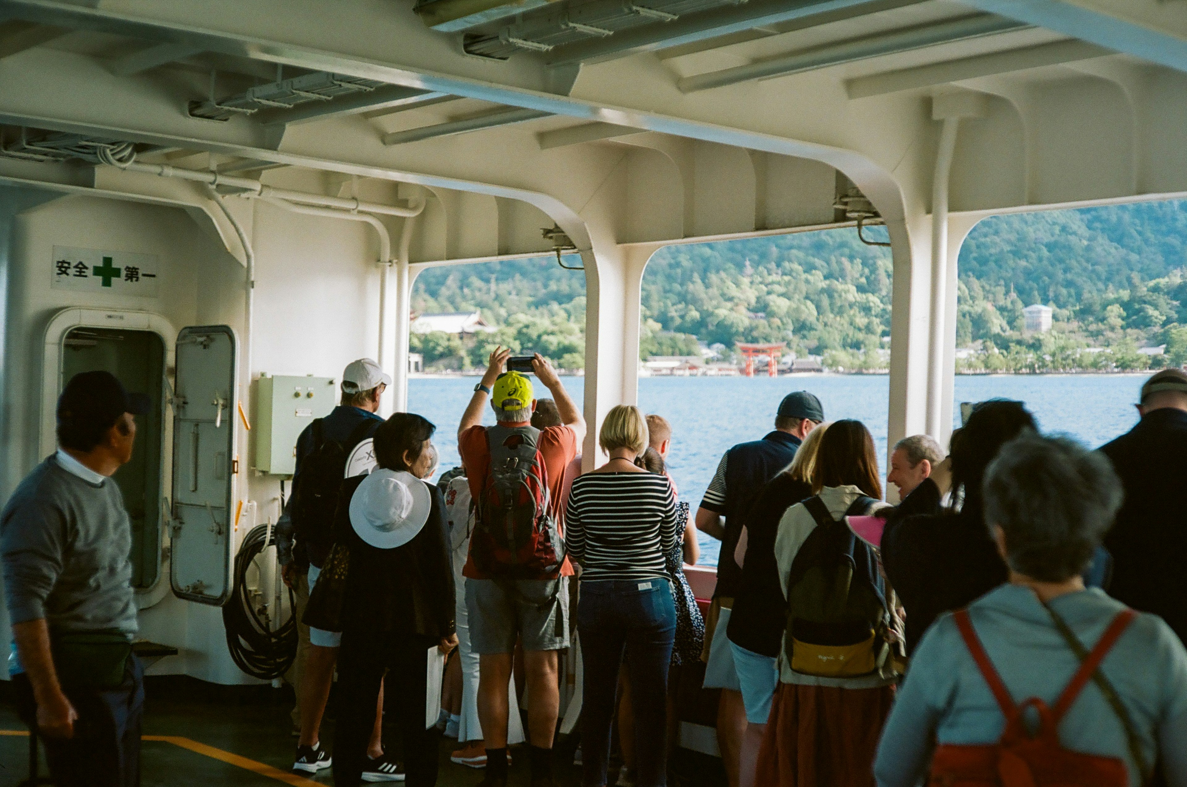 Tourists looking out at the scenery from inside a boat