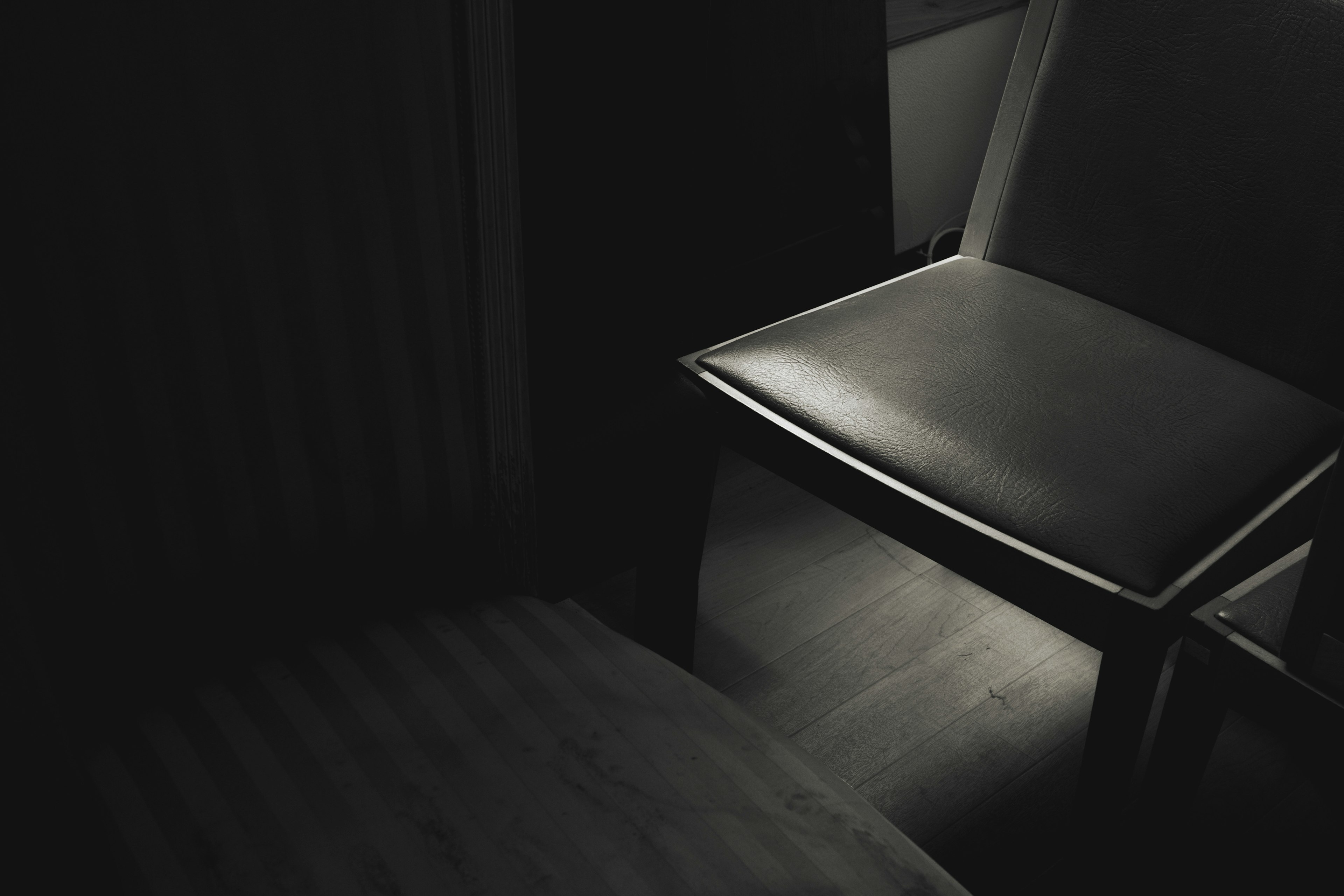 Partially illuminated chair in a dark room